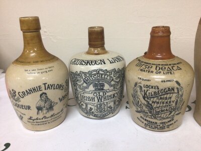 A collection of Victorian and later stoneware bottles including a salt glazed flagon stamped J W Phillips The Hoy South Benfleet. Irish whiskey bottles Cruiskeen Lawn Kilbeggan and Granny Taylor’s Scottish Liquor Whisky. (5) NO RESERVE.