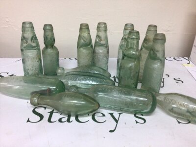 A Collection of Victorian small size Codd glass bottles all with moulded trade labels including Magarthy of Romford Harrington Southend H Frith Manningham other bottles including Morrish & Co Notting Hill and others.