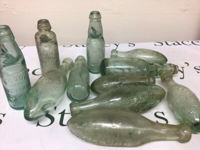 A collection of Victorian and later Codd bottles and other glass bottles all with moulded trade labels York Mineral Water Goodliff Chelmsford Albion Works Bury and many others NO RESERVE.