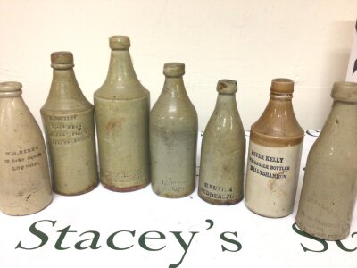 A collection of early 19th century salt glazed stoneware bottles with impressed, retailers and manufacturers details. E Buckley Boars Head Stanley Bridge The Crown Buildings Halifax and others (7) NO RESERVE.
