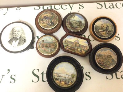 A collection of Eight pot lids decorated with views of the 1862 British International Exhibition The Philadelphia Exhibition 1876 The Chapel Royal Savoy destroyed by fire 1864 a tea pot stand with portrait of Gladstone. (8)