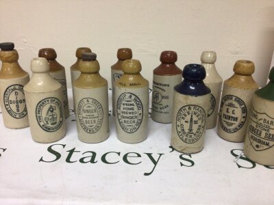 A collection of Stoneware Ginger Beer Bottles including local breweries Eddrup & Wood Pall Mall Leigh Bonnett & Green Southend Diggs Glendale Gardens Leigh and many others (12)