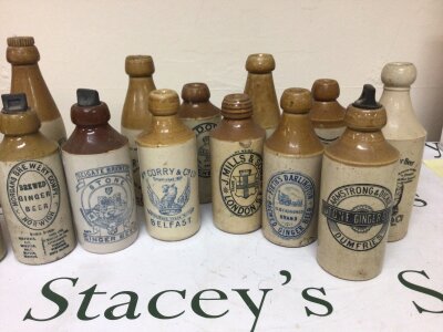 A Collection of Victorian and later Beer and Ginger beer stoneware bottles with applied trade labels. NO RESERVE.