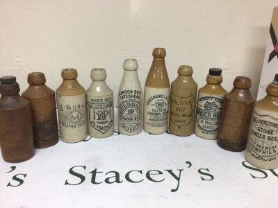 A collection of Antique stoneware and salt glazed Ginger Beer and Mineral bottles.