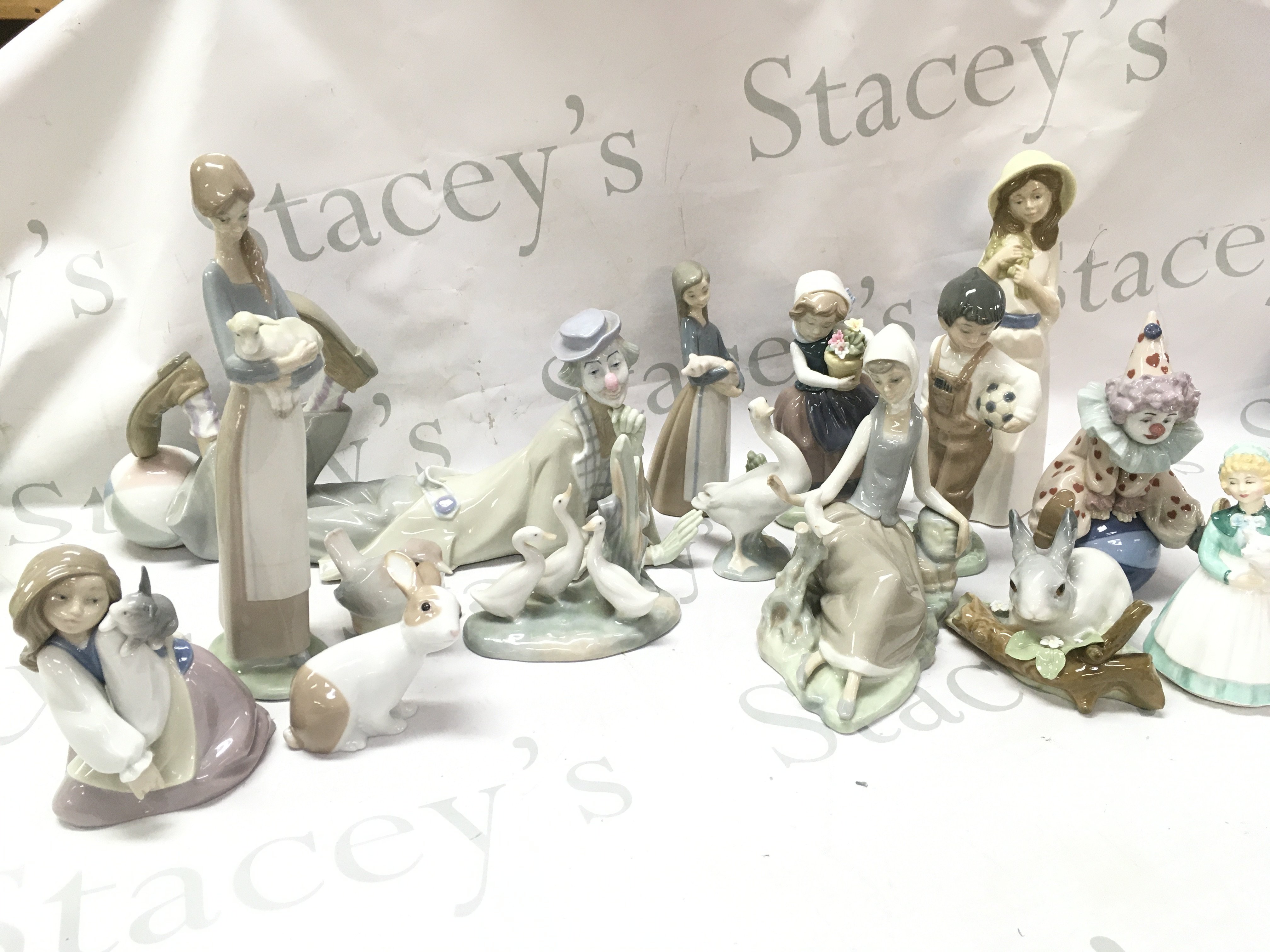 A collection of Ceramic figures including Royal Doulton , Lladro, Nao etc . This lot cannot be posted