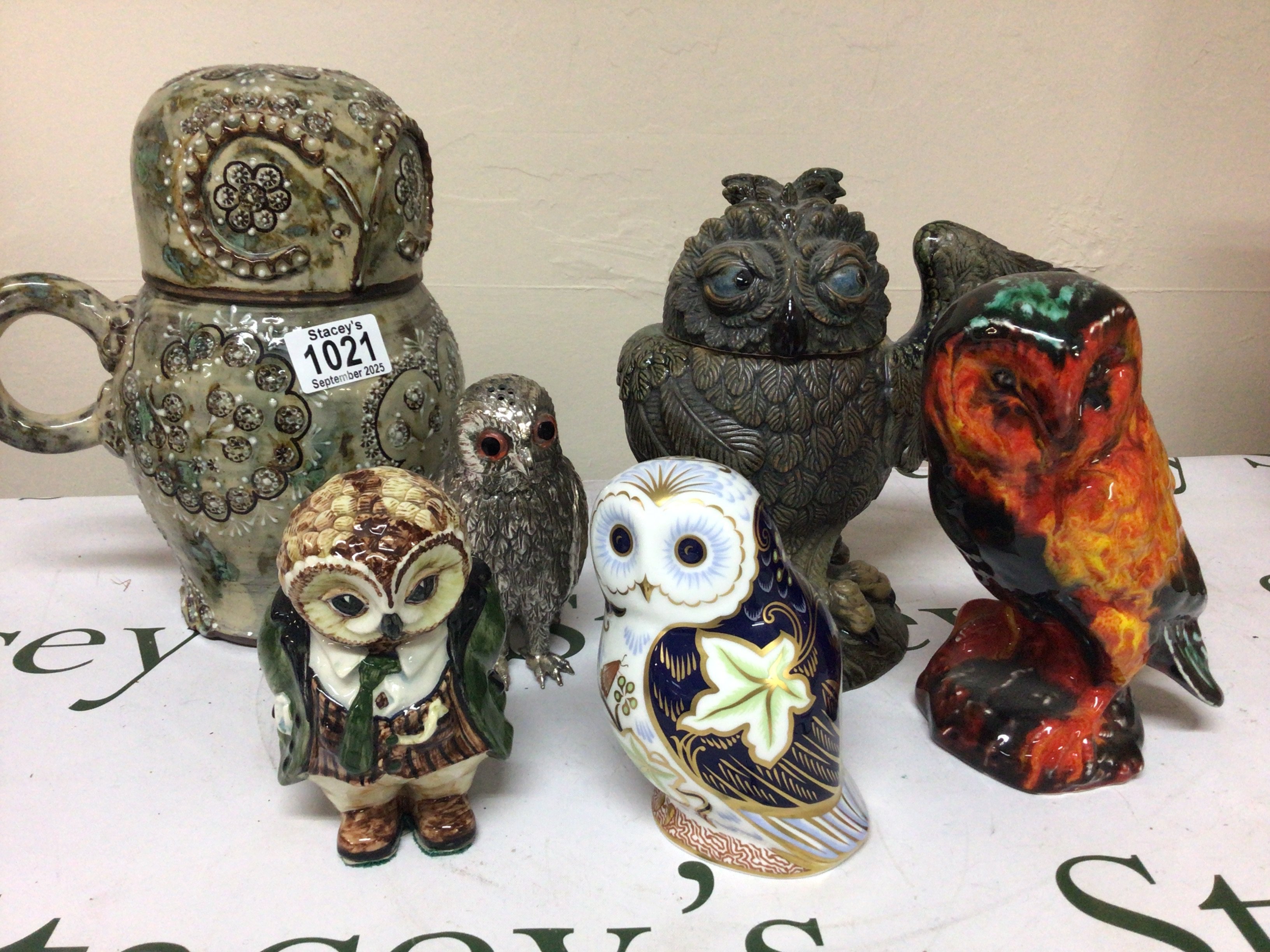 A Collection of Owl ornaments including Royal Crown Derby Twilight Owl a large slip decorated ceramic owl pot and cover with a handle and a 20th century Martin Bro Style Owl and others (6)