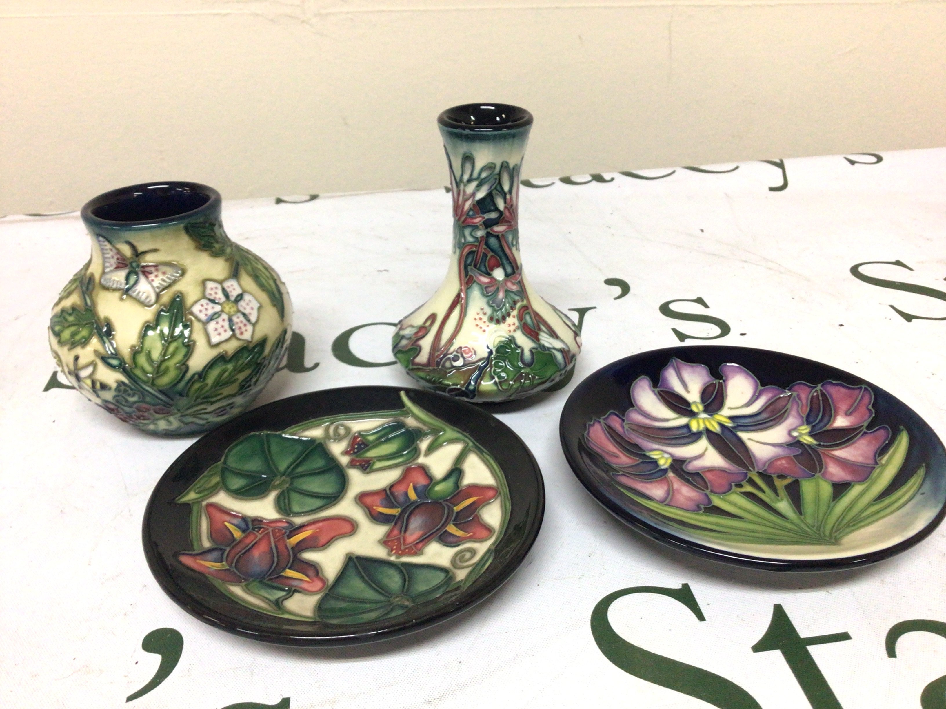 Two small Moorcroft dishes and two vases no obvious damage marks to the bases. Height 11cm