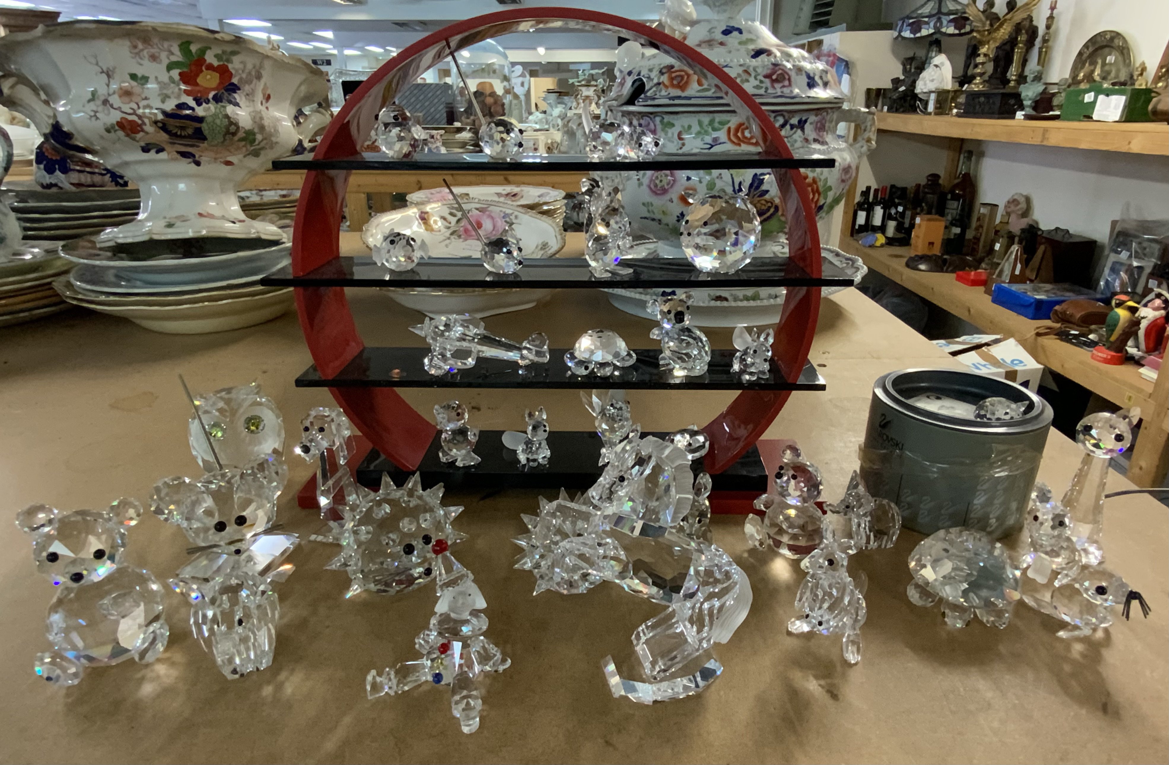 A good collection of Swarovski crystal figures including a Swarovski Perspex stand. (Some figures with damage).