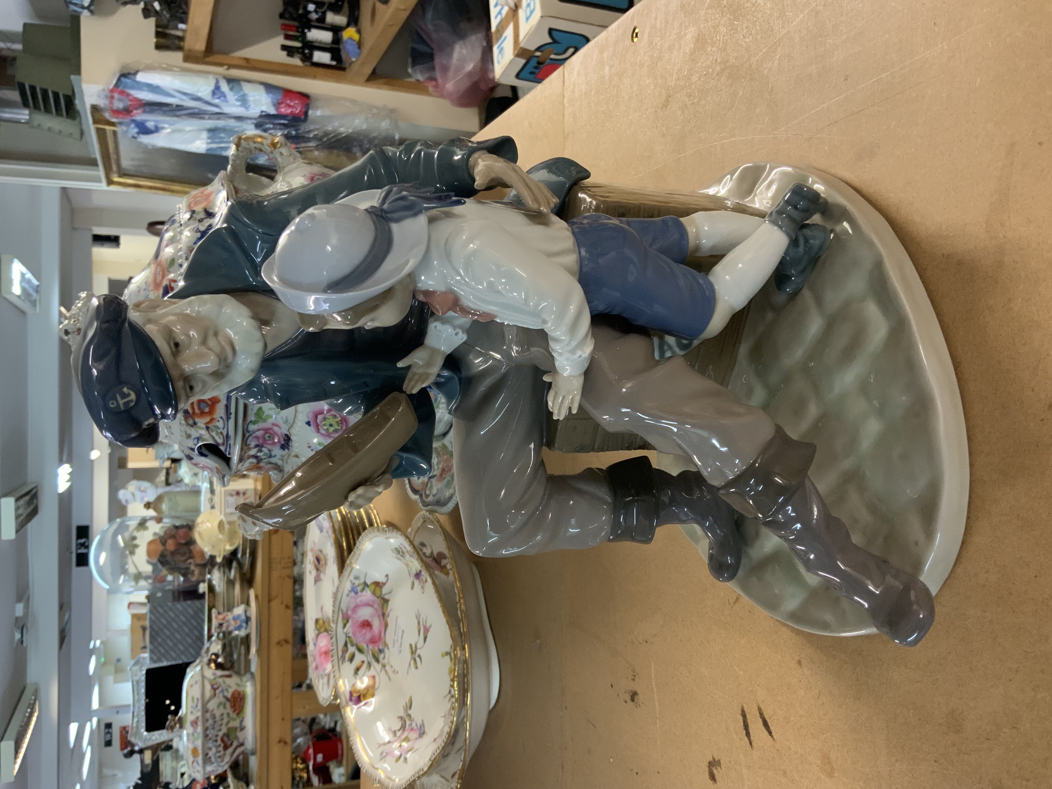 A Lladro Figurine of a Fisherman & Boy (A Tall Yarn).