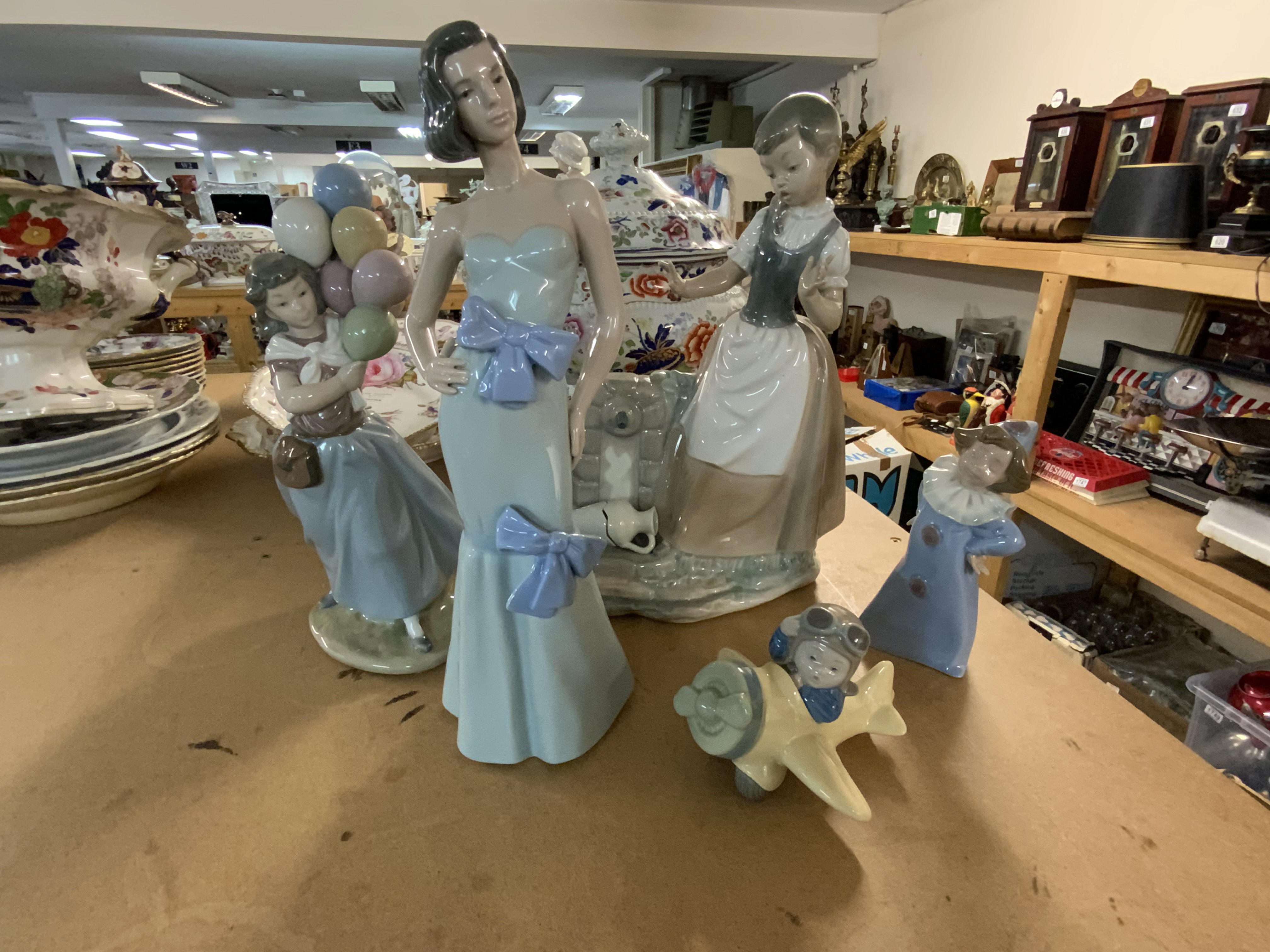 A small collection of Lladro and NAO porcelain figurines.