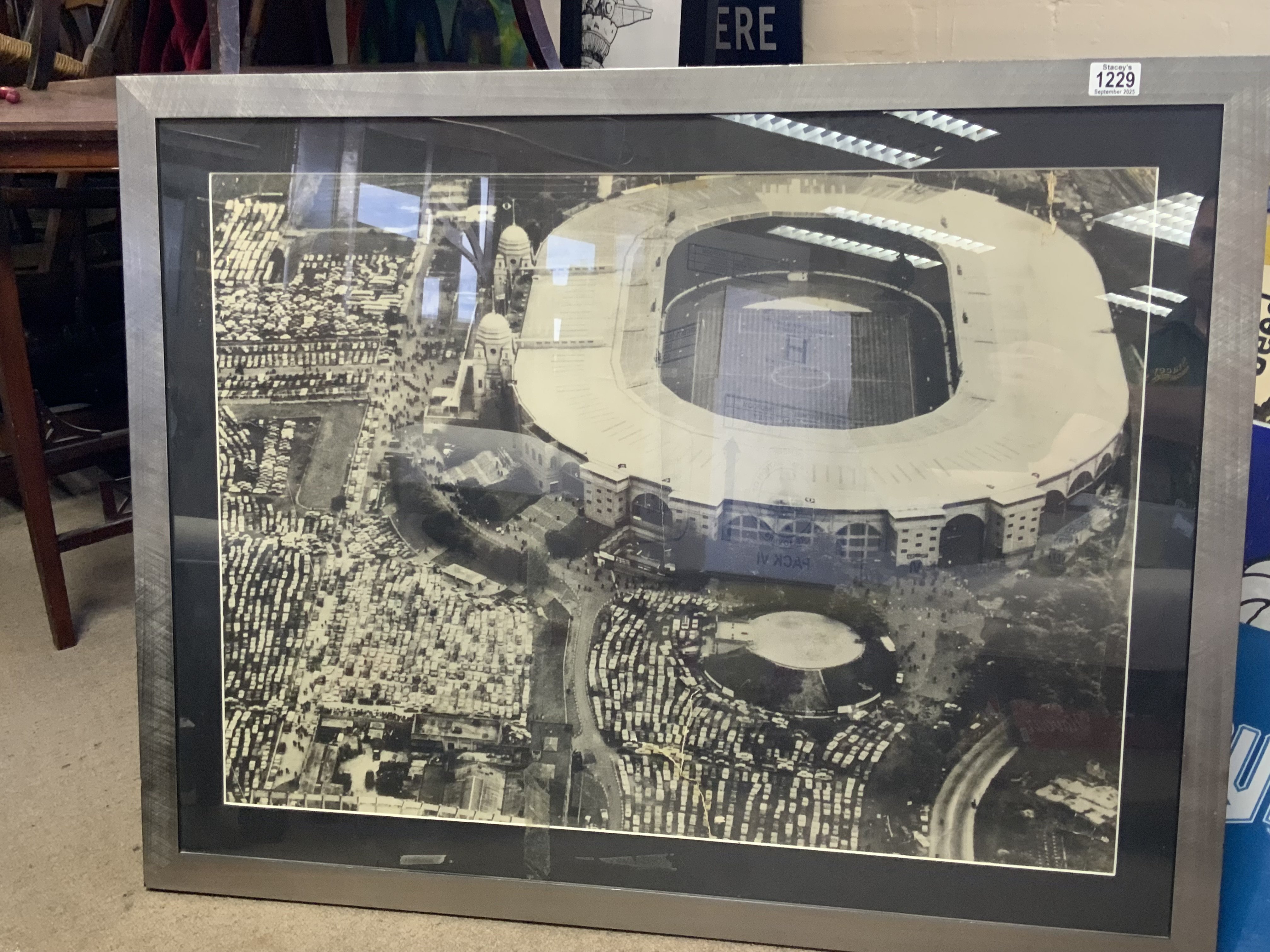 A large framed photo of Wembley Stadium c.1970s (some damage) .98cm x 76cm