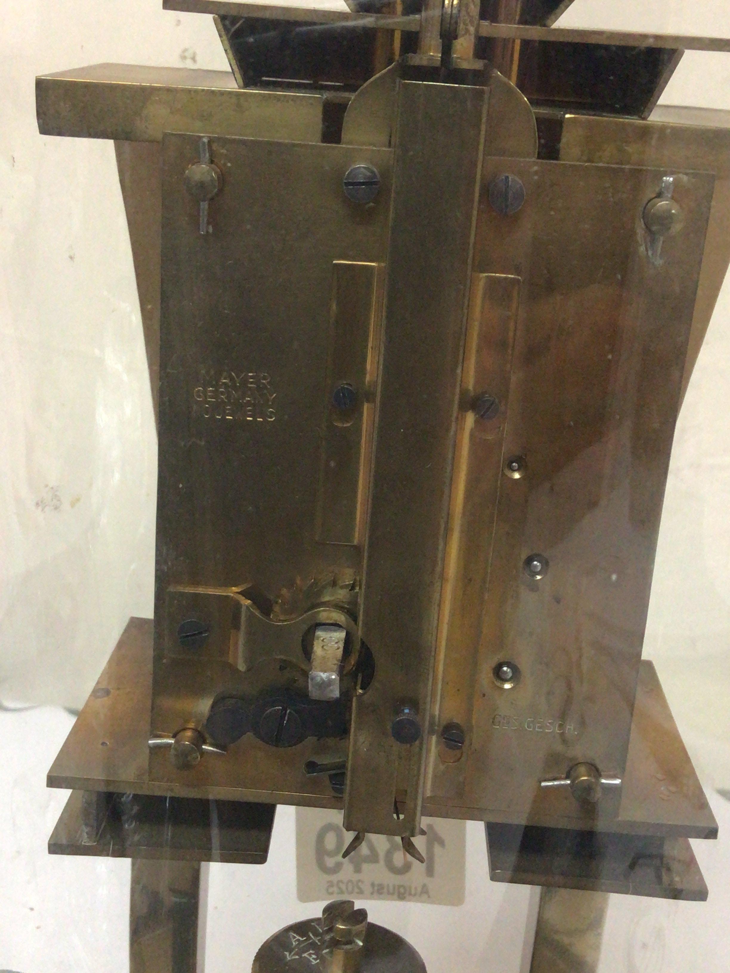 An Art Deco German Anniversary clock under a glass dome with metal pillars dome no damage clock for restoration.Height 32cm.- NO RESERVE