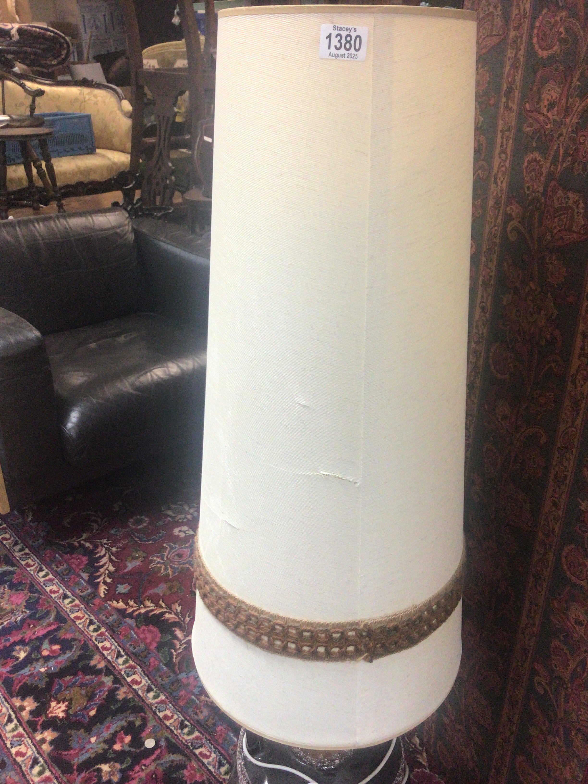 A mid 20th century floor lamp with a brown glazed ceramic base and elongated shade.- NO RESERVE