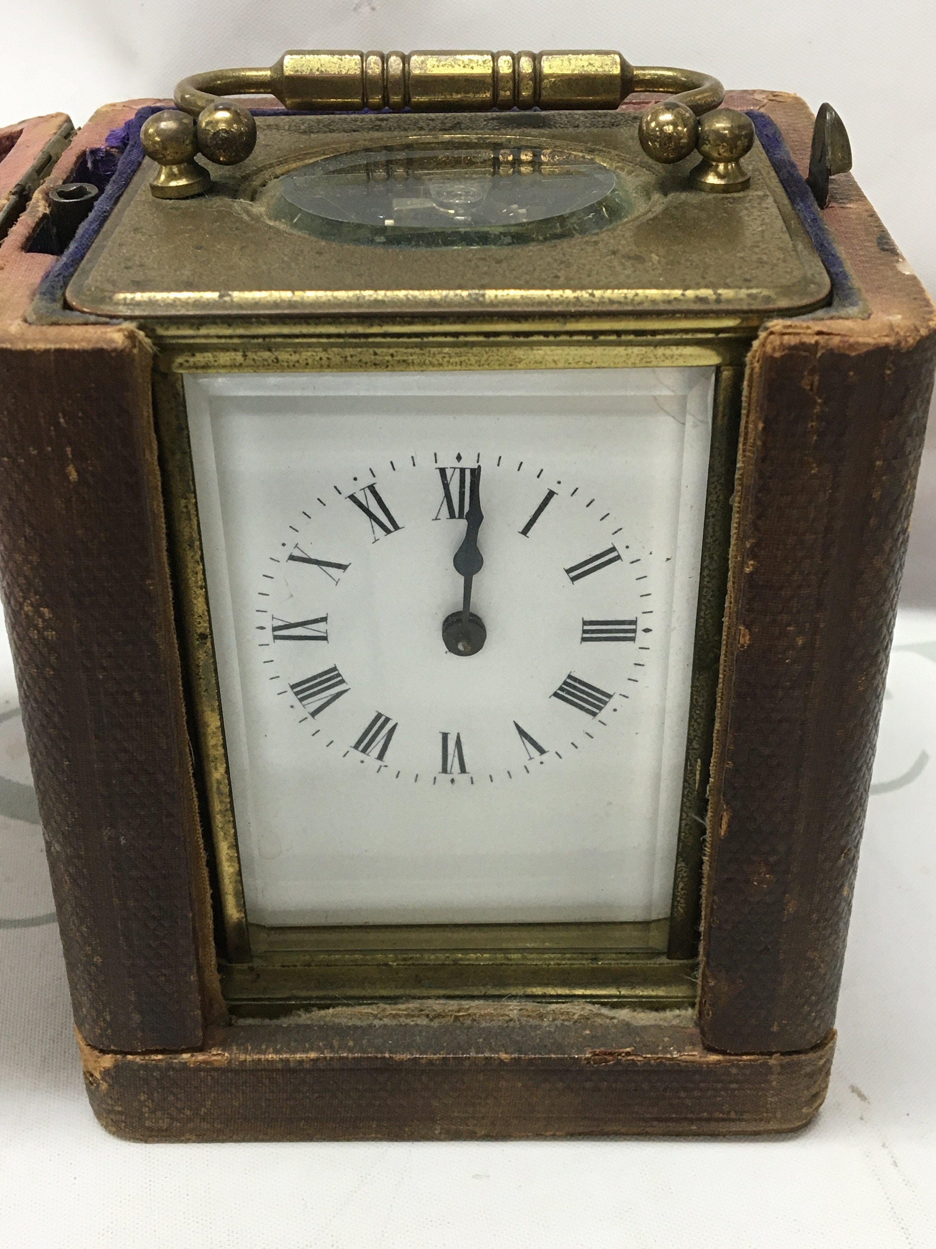 A brass cased carriage clock the enamel dial with Roman numerals. Fitted in original case .