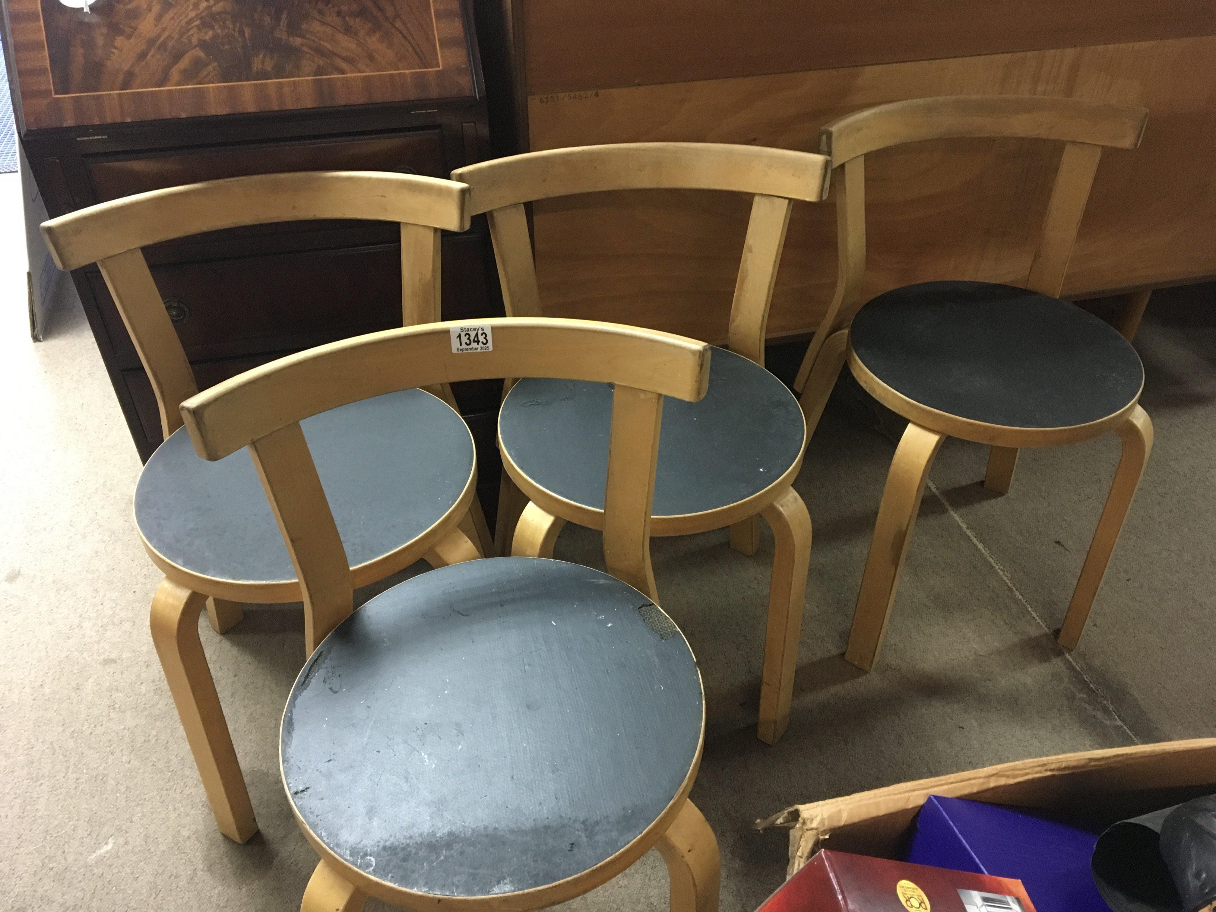 A set of four Alvar Aalto chairs .