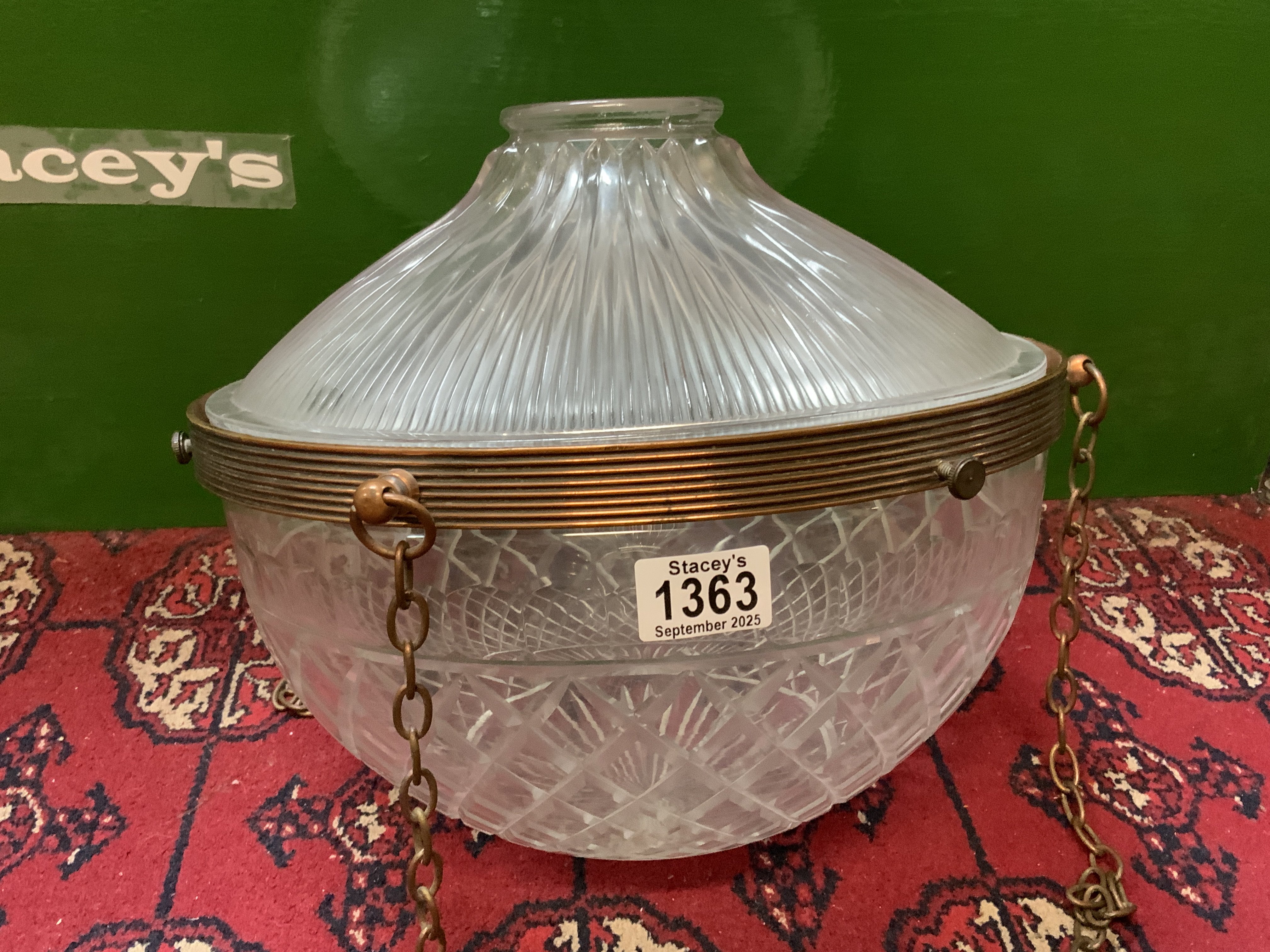 A 1940s Cut glass lamp shade with copper finished mounts and chains with additional homophone pressed glass cover. 32cm Diameter x Depth 34cm. (Slight rim chips).