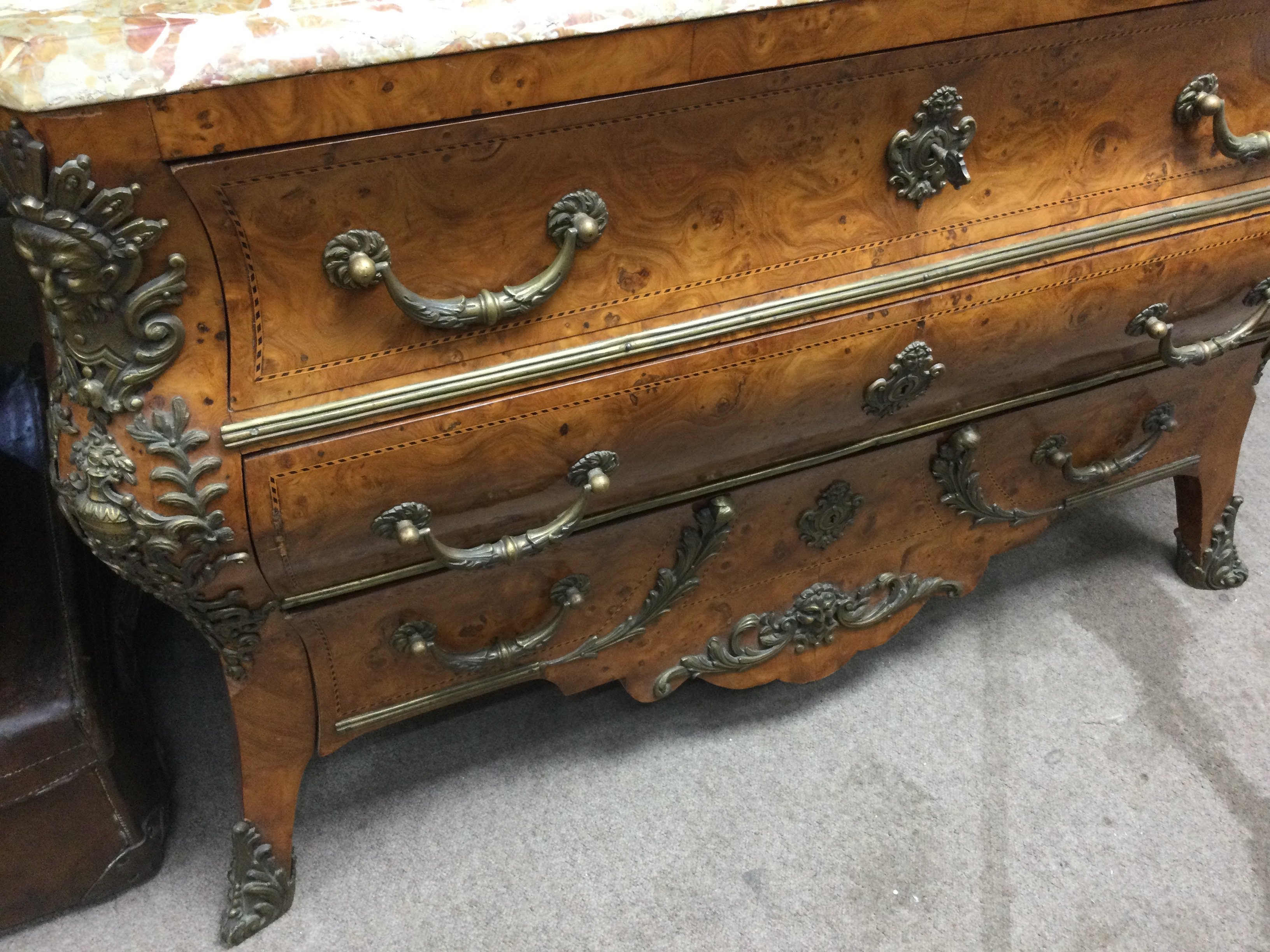 A Louis XV style bombe commode with brass applied mounts the Marble top above three drawers .50 cm x 125 cm height 90 cm .