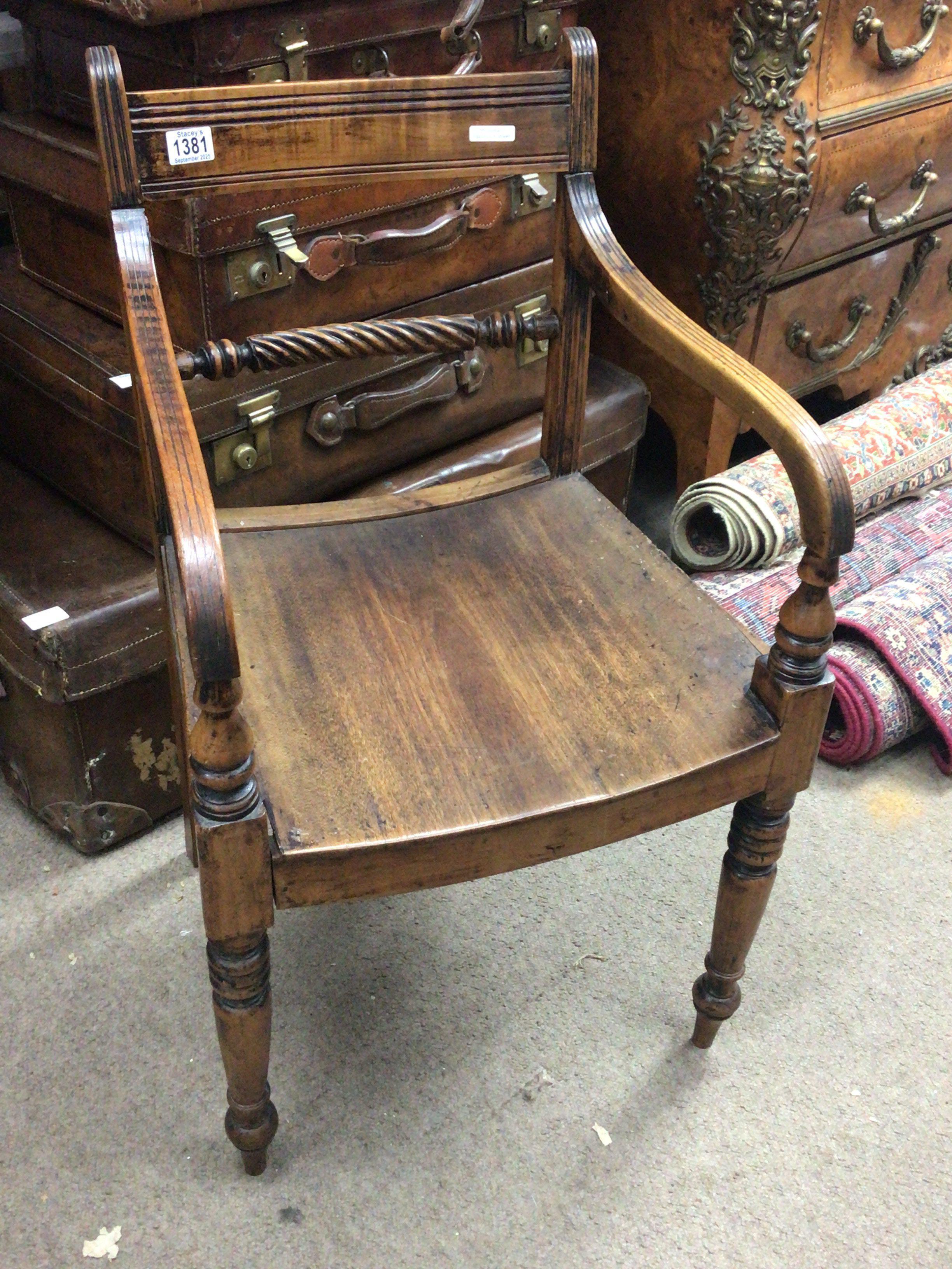 A 19th century Elm and Beechwood Vernacular open arm chair most likely East Anglia. With rope back and curved seat.