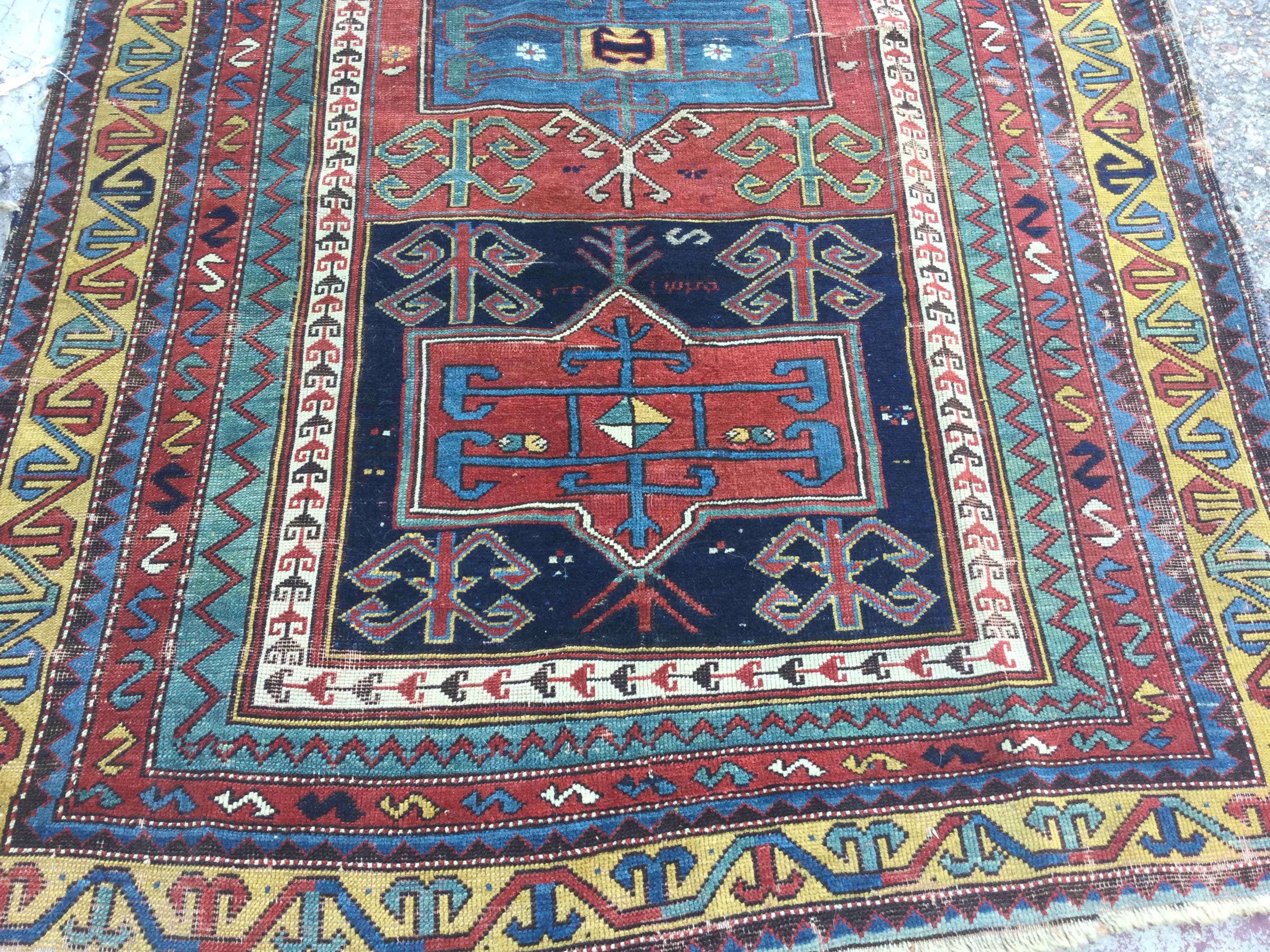A Kazak rug with geometric centre and repeated pattern boarders. 225 x 140 cm .