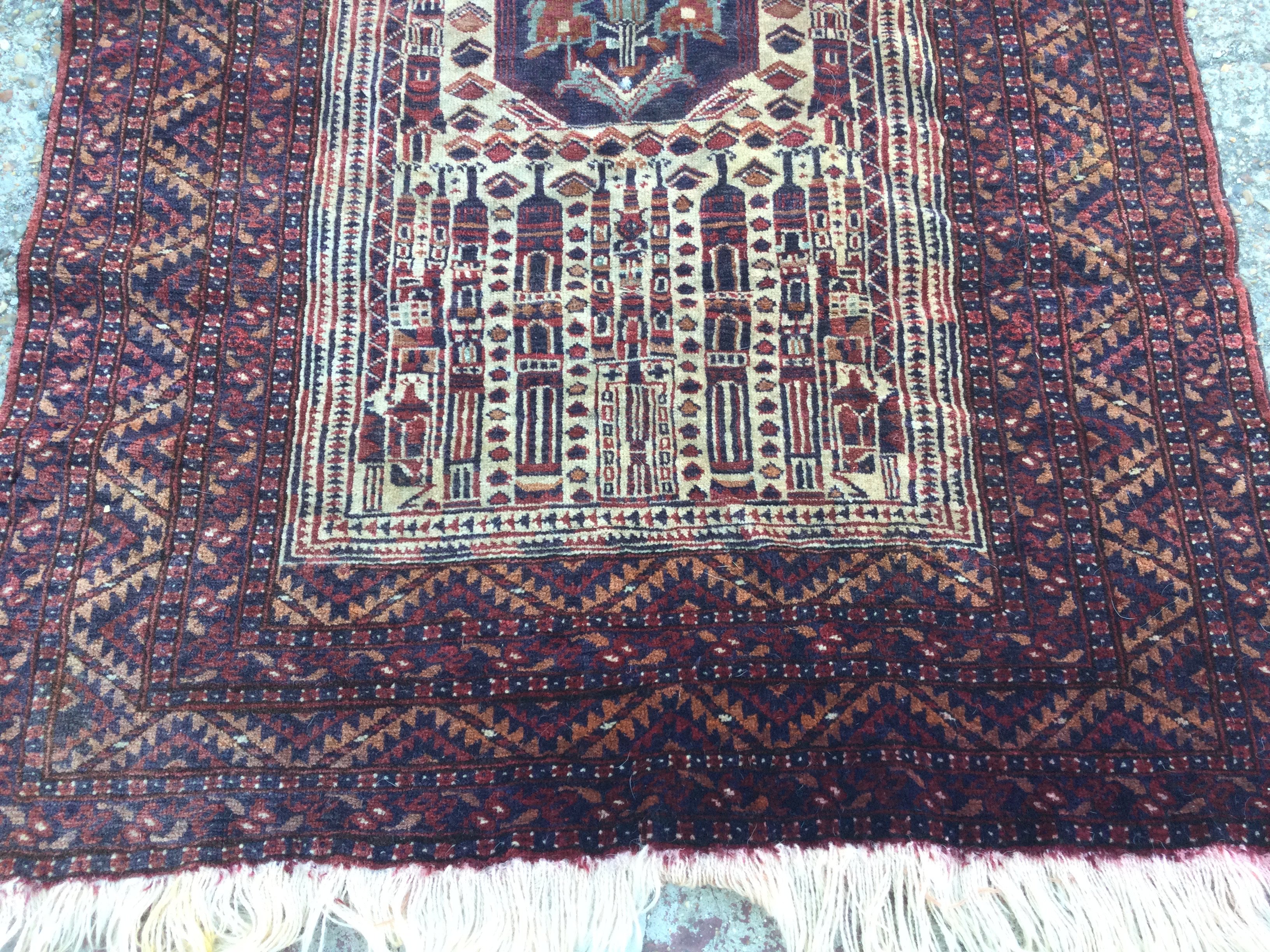 A Afghan rug with a central motif and repeated geometric boarders.170 x118 .
