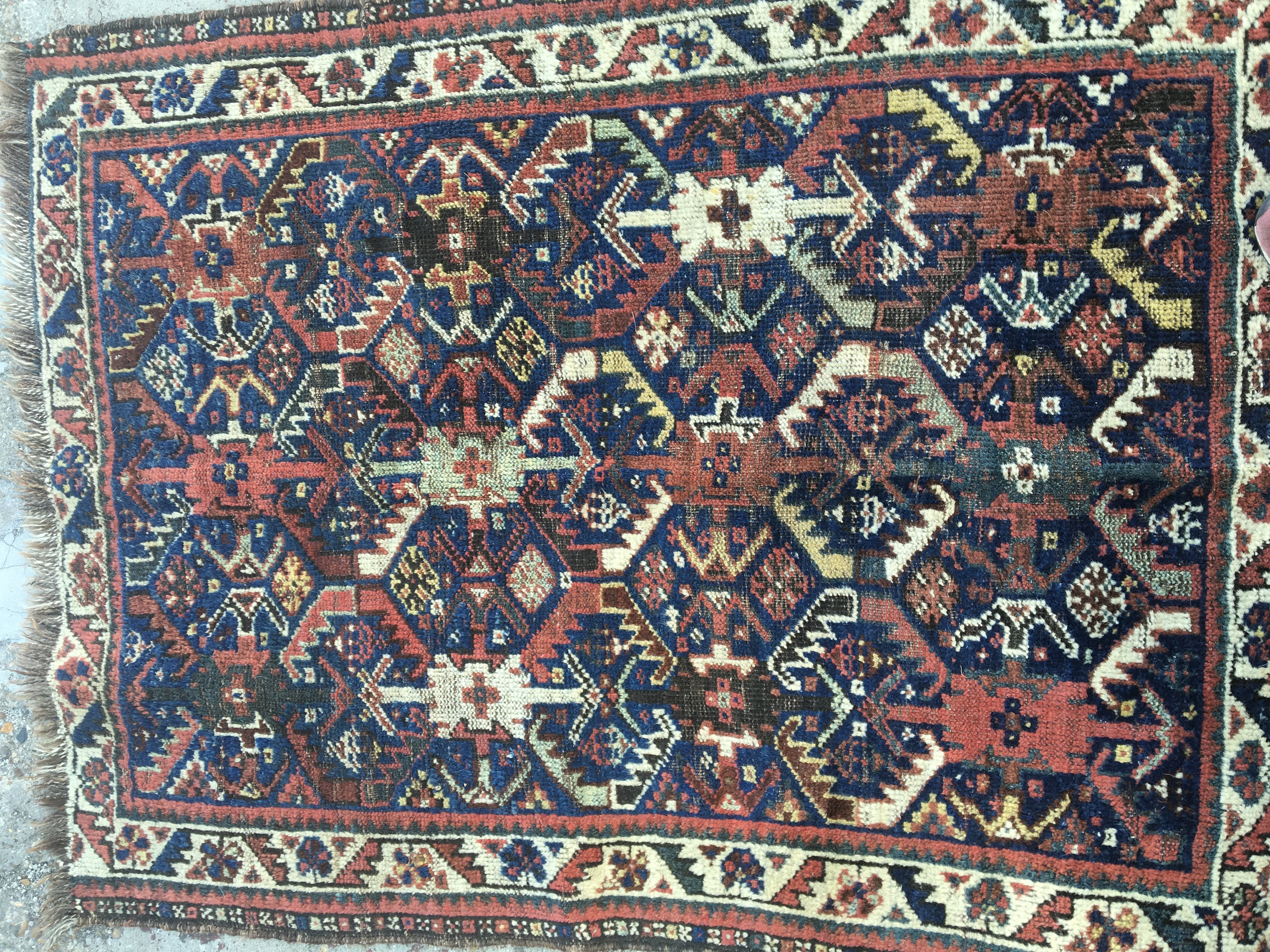 A small Persian rug with geometric design. 120 x 86 cm