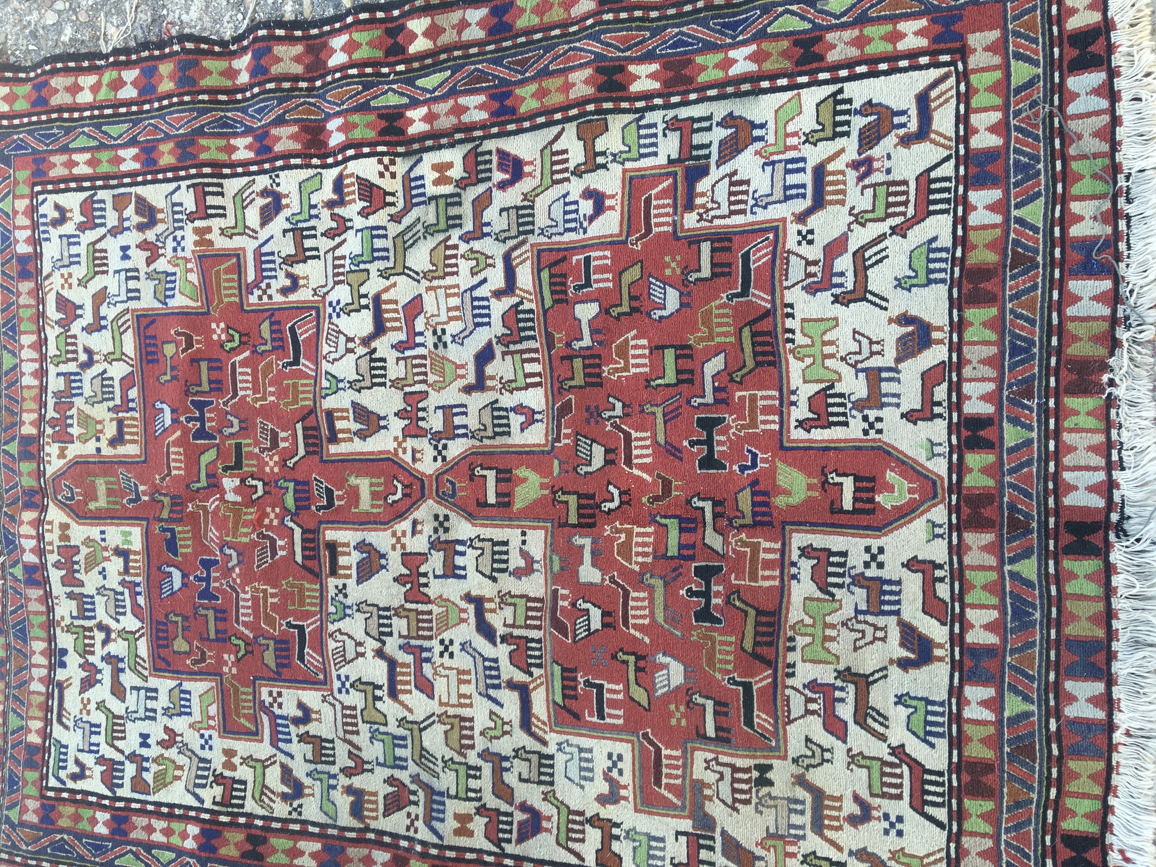 A Soumak rug the central field with Animal design and repeat pattern boarder . 140 x 116 cm .