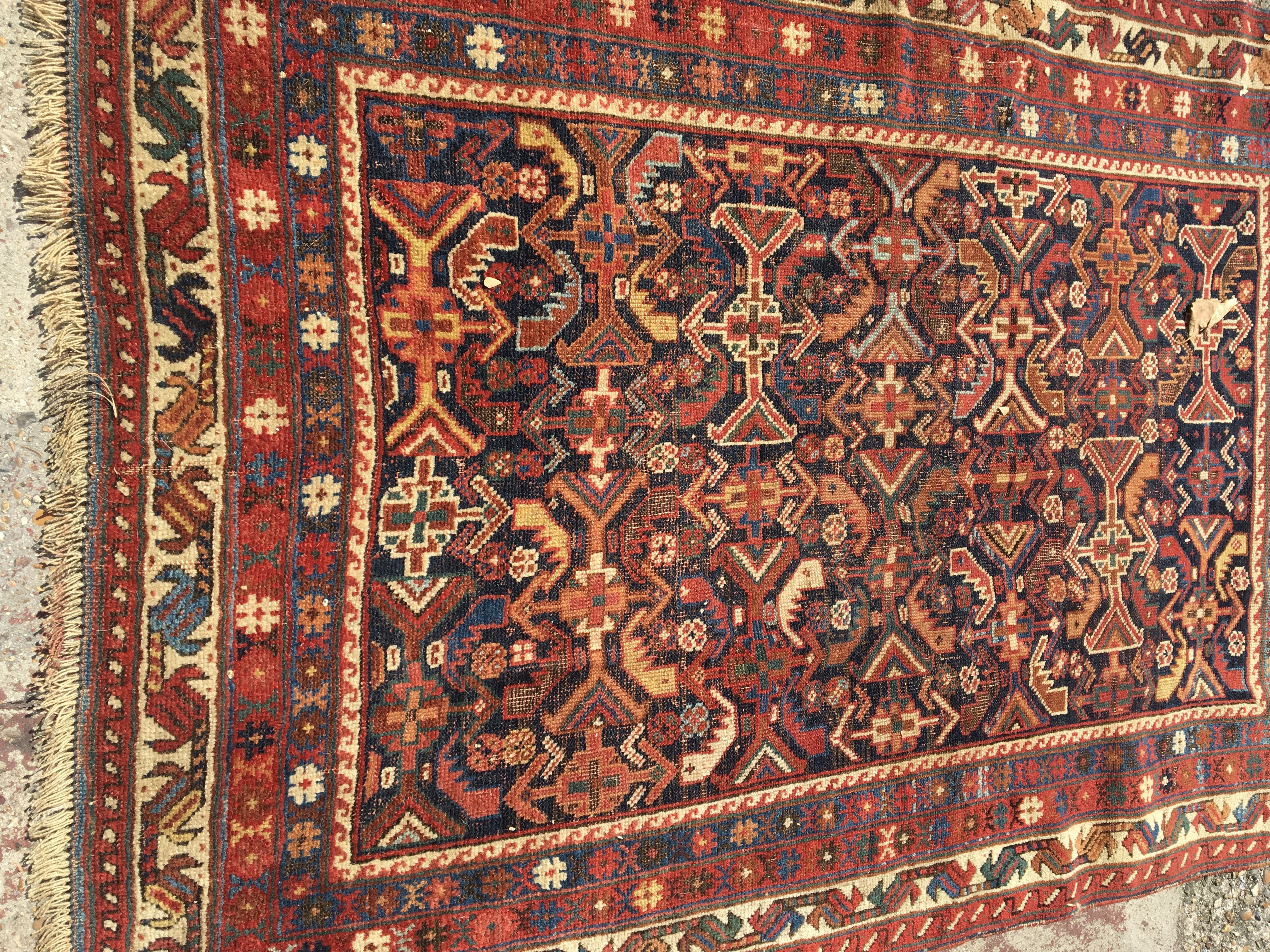 A Persian rug with geometric fields and repeated pattern boarder. 145 x 100 cm .