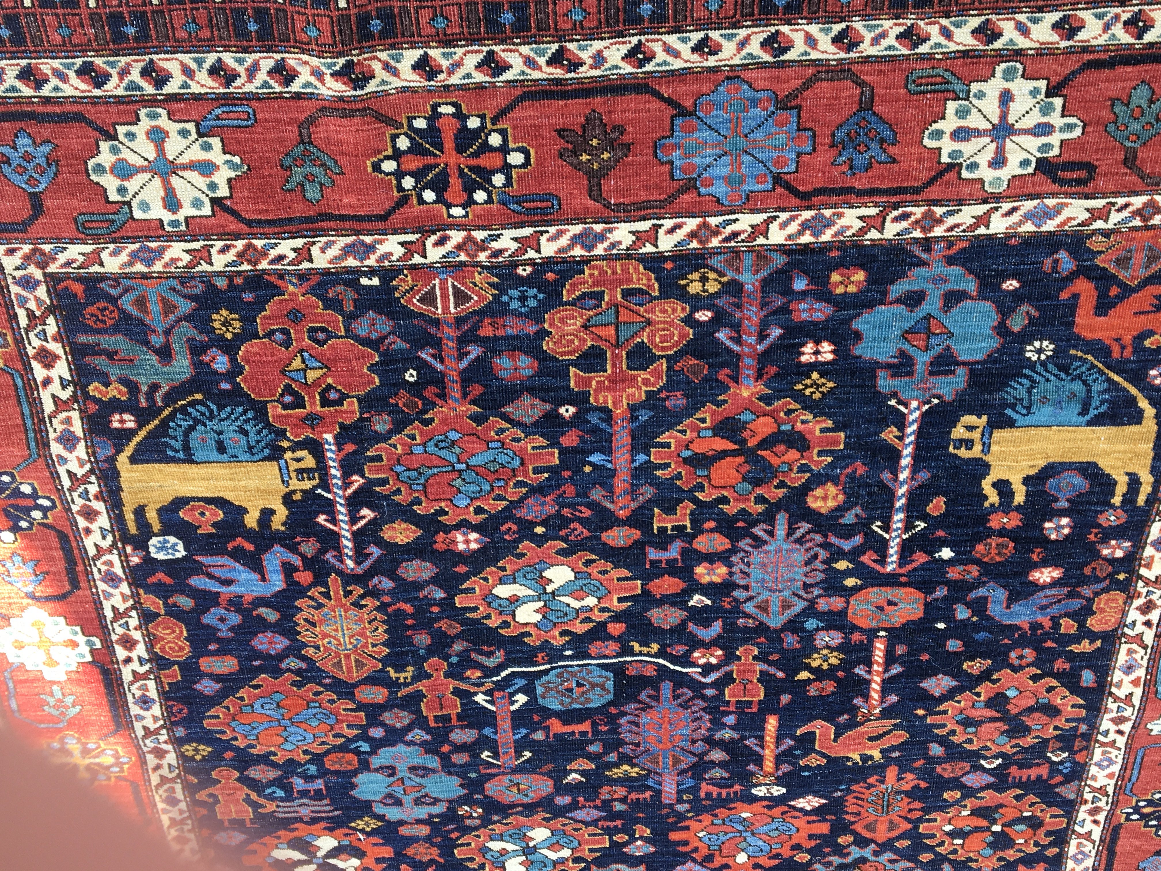 A Persian rug with geometric and animals field and floral boarder. 196 cm x 150 cm .