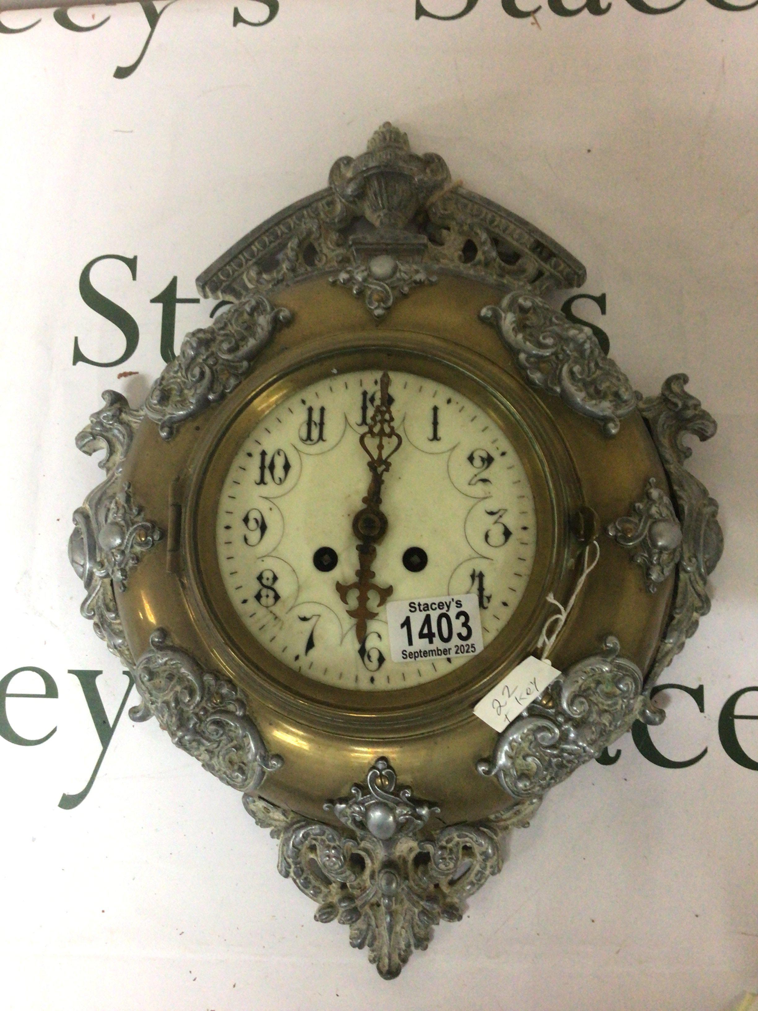 A brass and cast metal wall clock with an enamel dial for restoration. Diamter 33cm approximately.