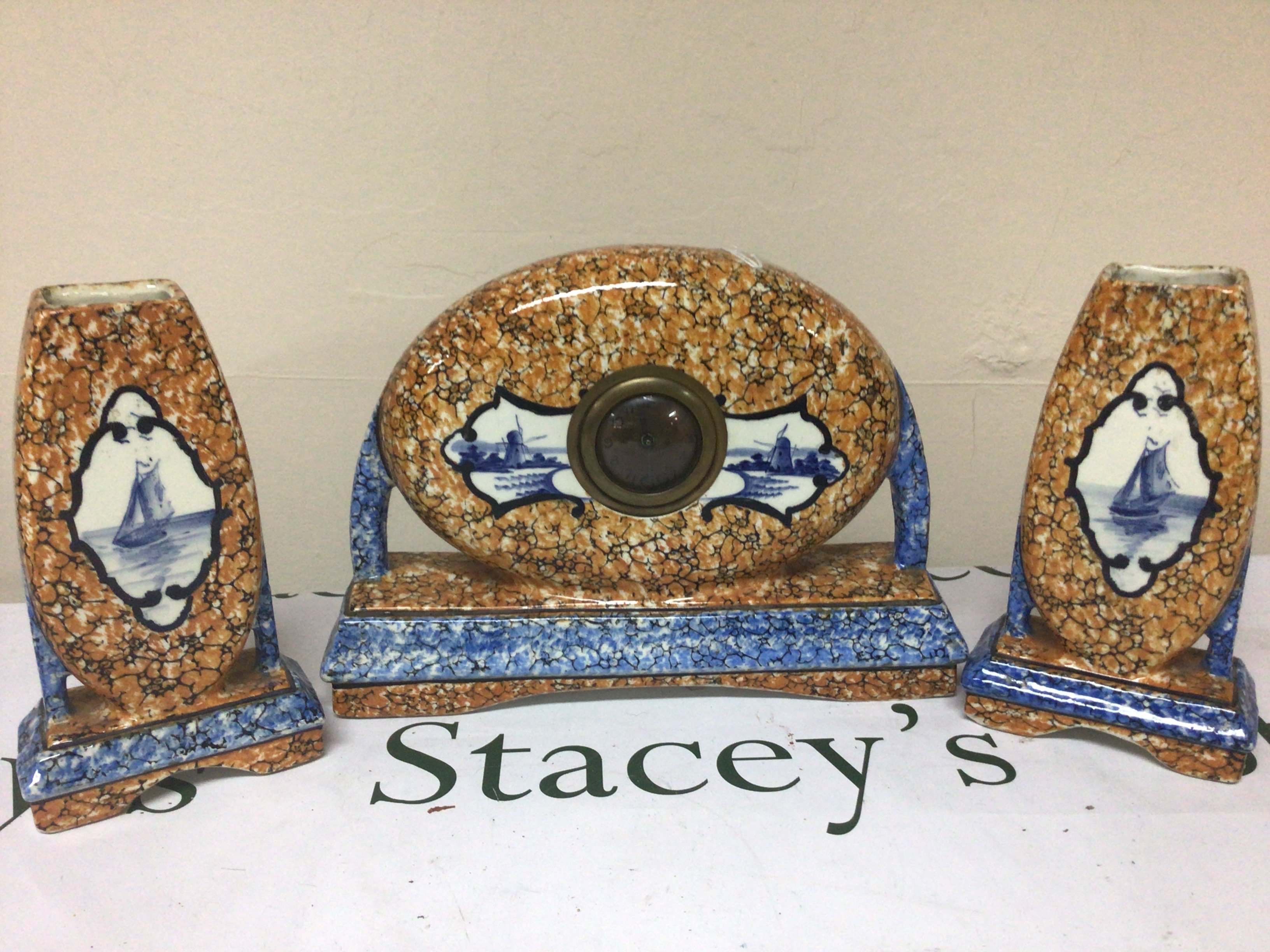 A Dutch ceramic clock garniture of Art Deco design decorated with traditional Delft panels. Height 24cm