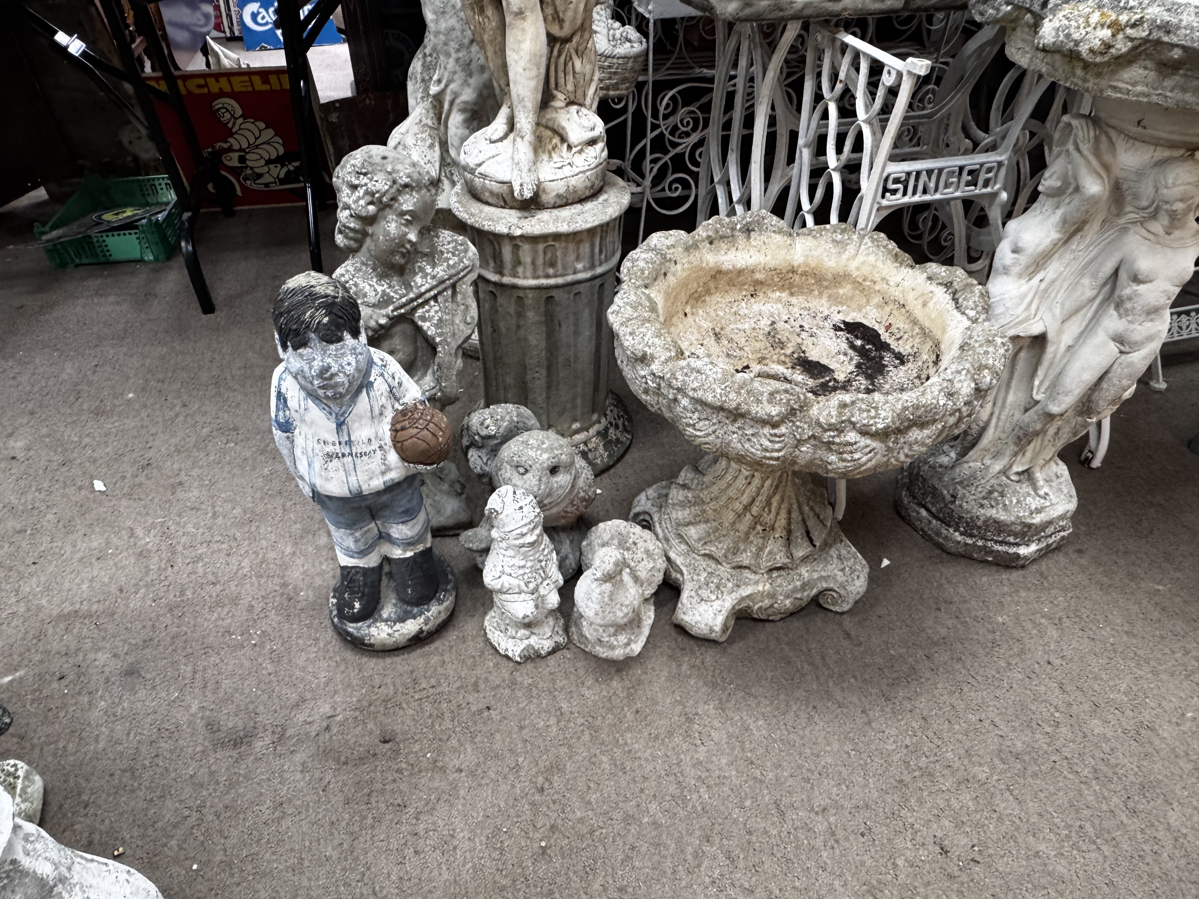 A mixed lot of garden statuary. 7 pieces to include nude maiden, cherub playing a violin, planter 4 smaller figures.