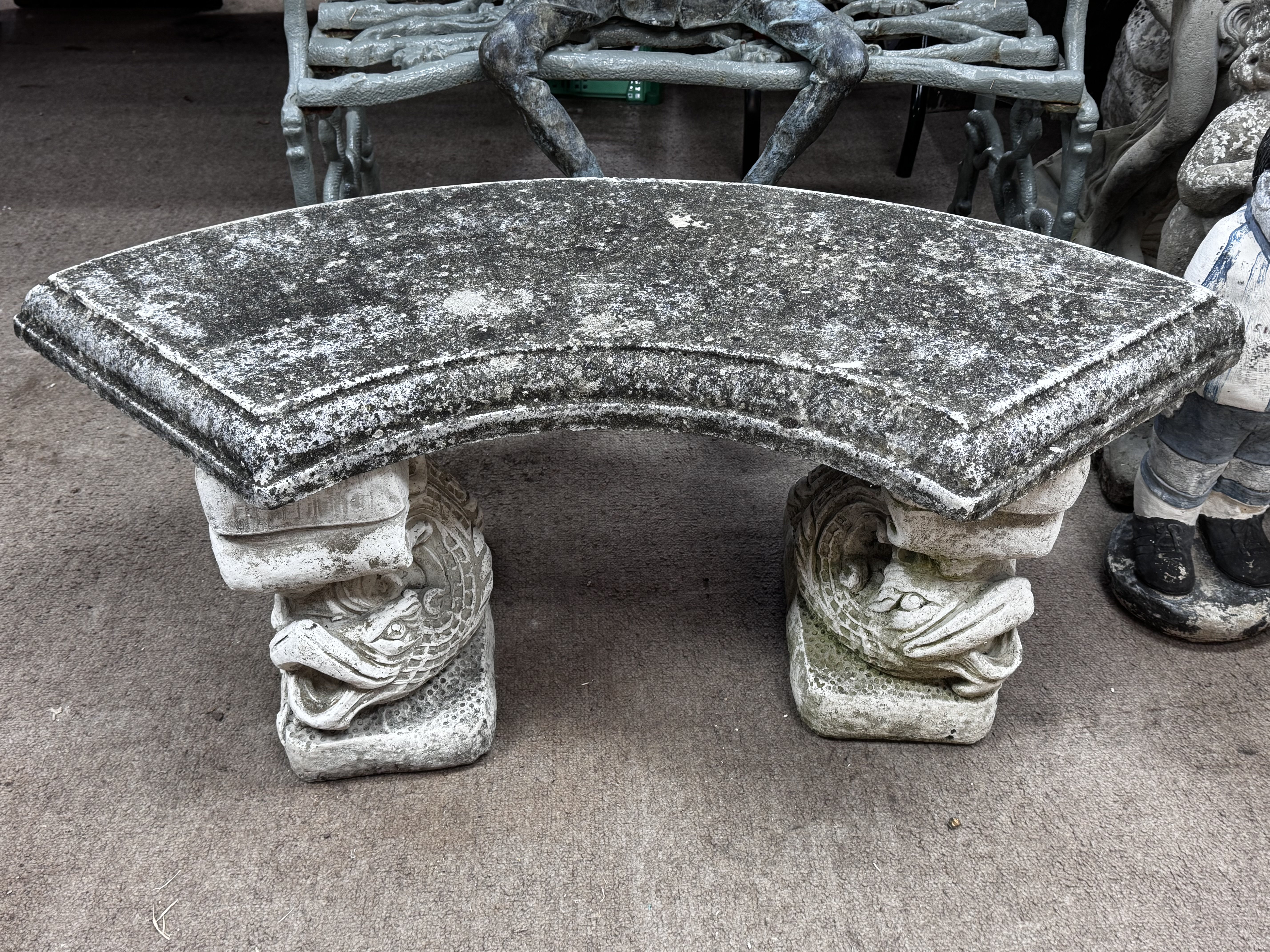 A cast concrete garden seat.