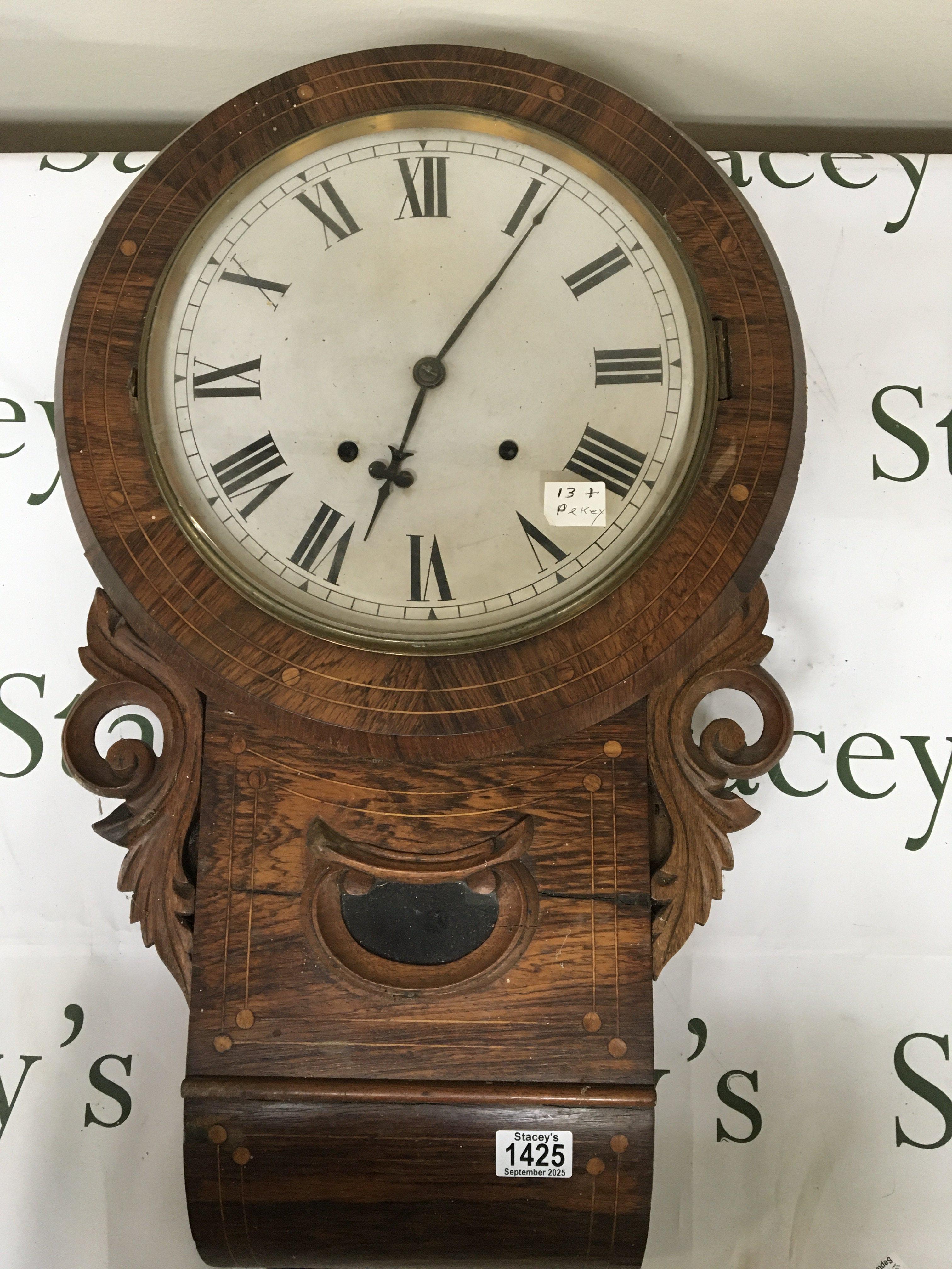 A late Victorian inlaid rosewood cased wall clock with key and pendulum 41cm diameter 70cm length
