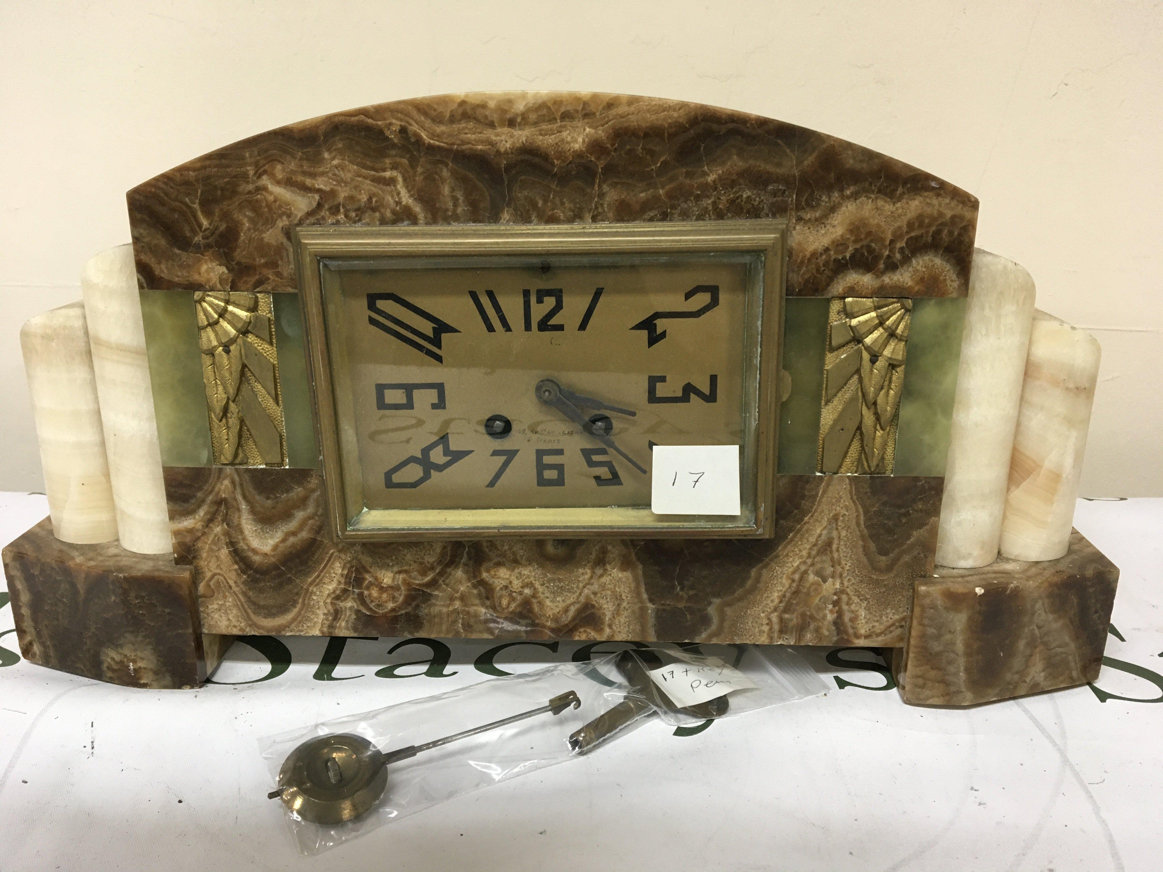 An Art Deco French marble mantle clock with key and pendulum. the rectangular dial with Paris maker length 45cm