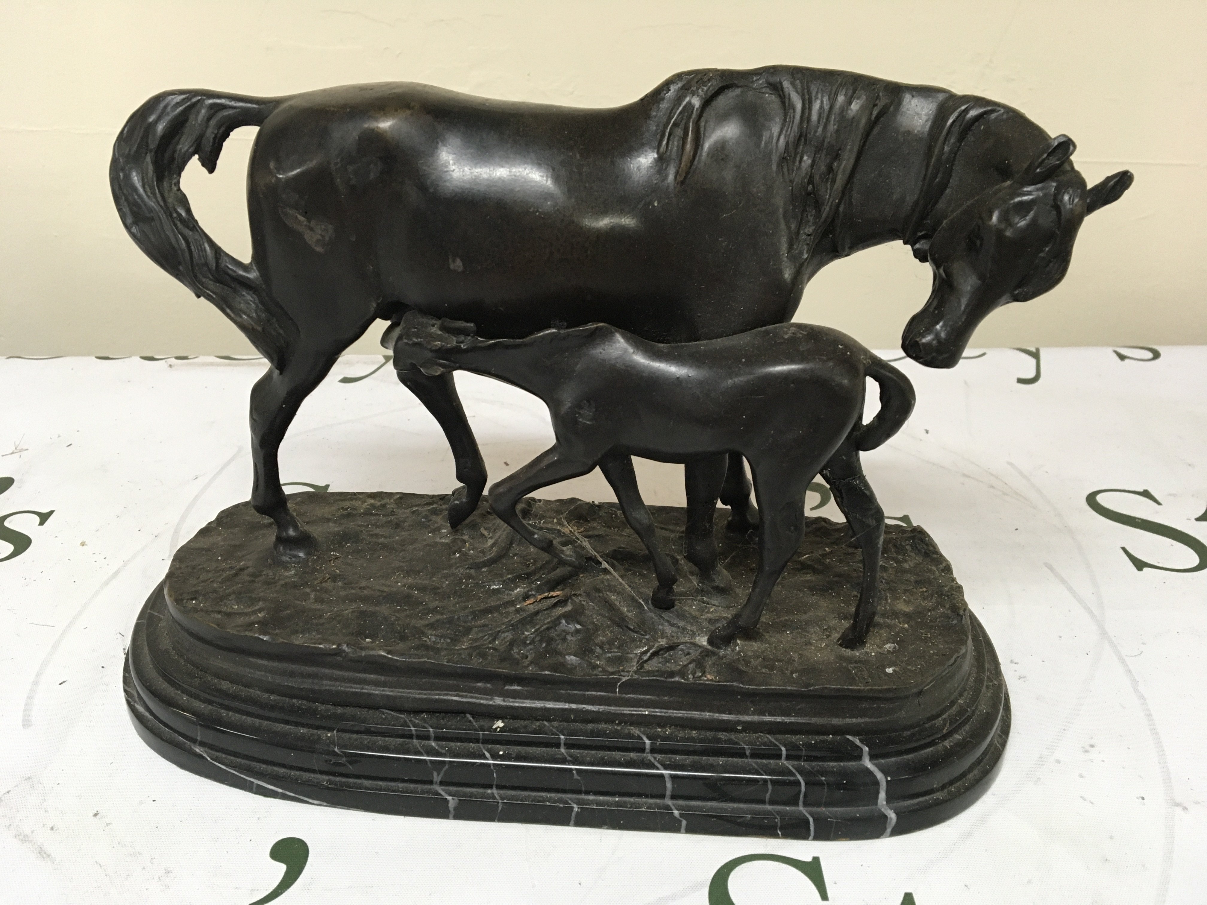 A bronze figure of a horse with foal on a stepped marble base. Heigh 21cm.