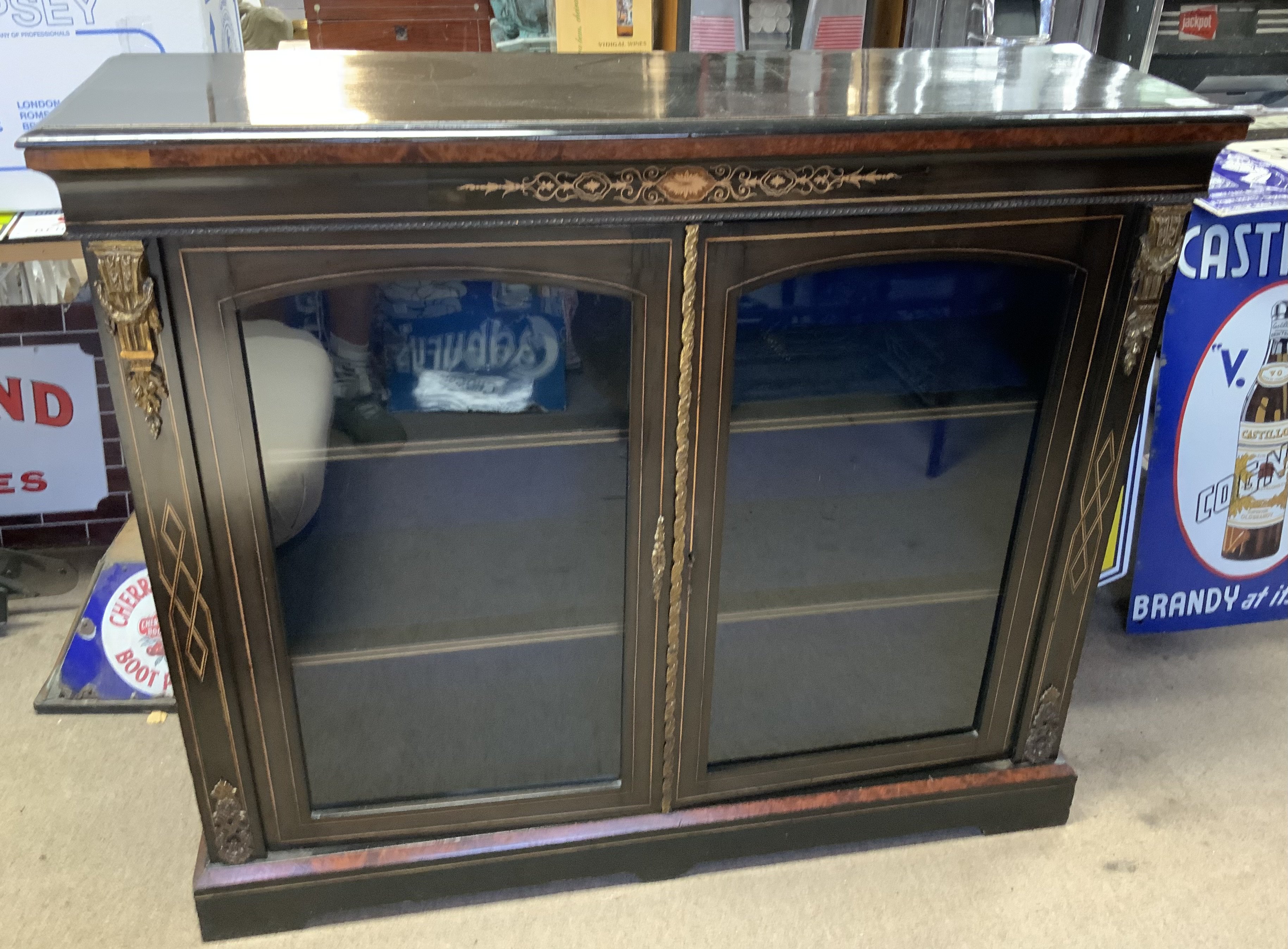 A Victorian Ebonized double width pier cabinet with walnut and fruitwood inlay and gilt metal mounts. 119cm x 35cm x 102cm. (D)