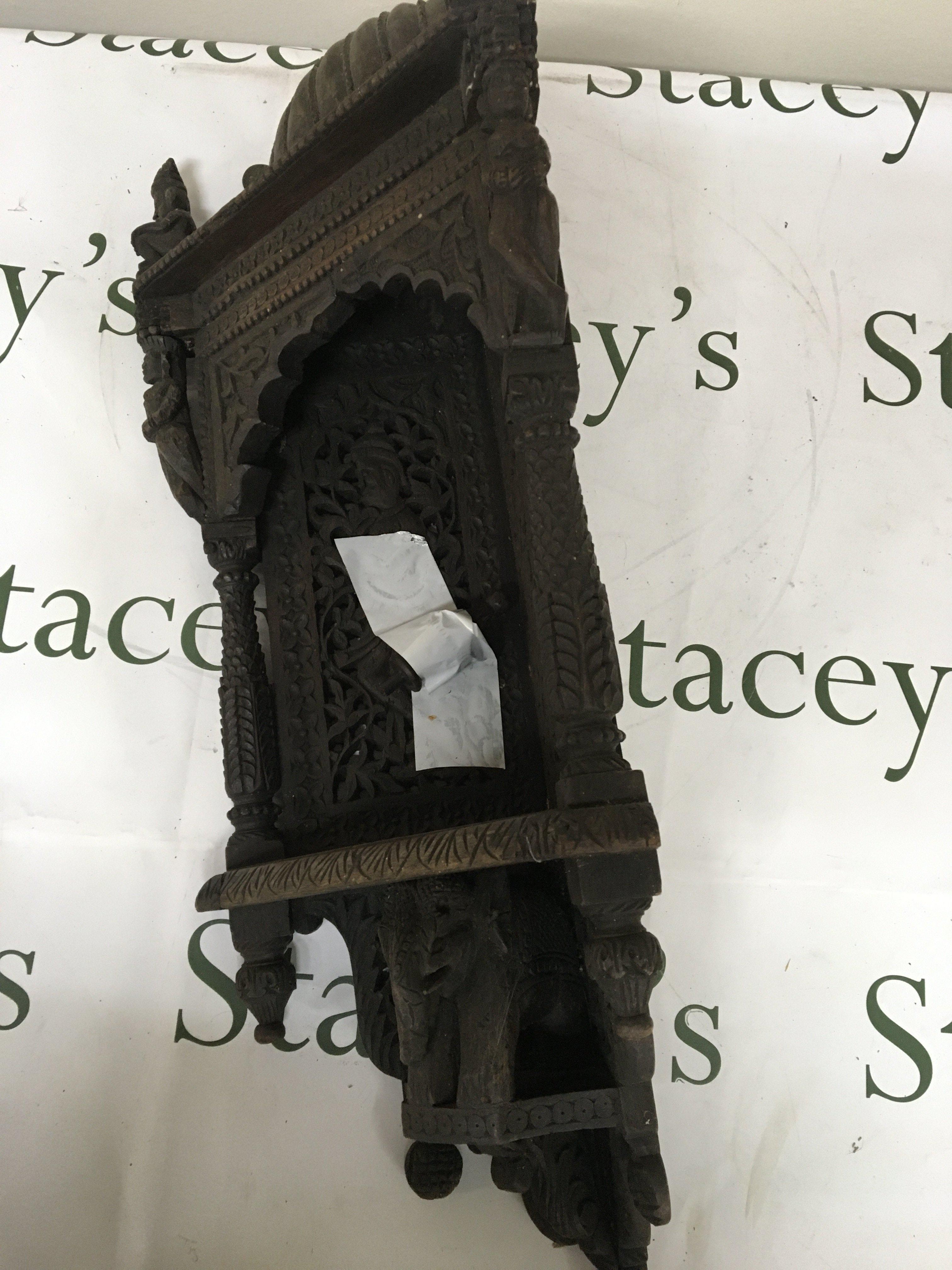 A 19th century carved hardwood Indian corner bracket. Profusely carved with raised figures.