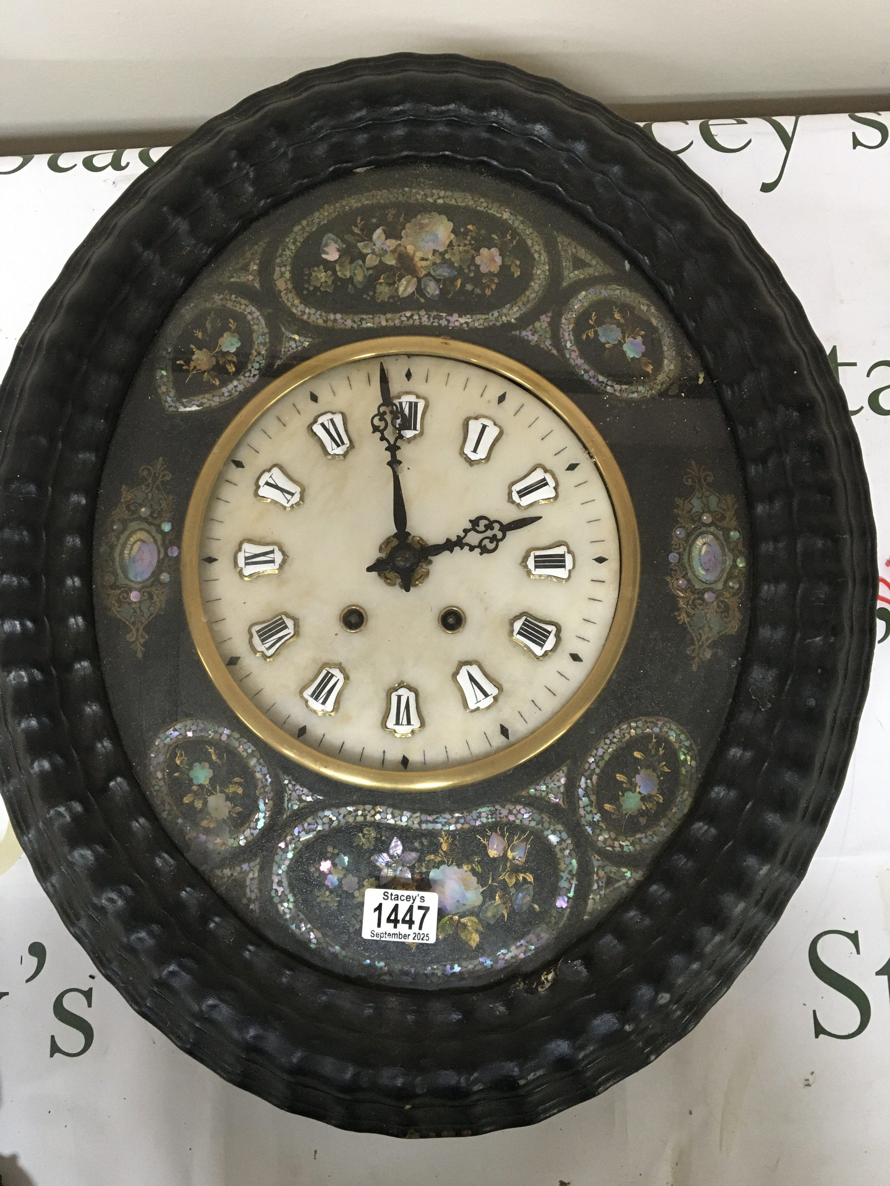 A Continental wall clock inlaid with mother of pearl and with a white marble dial with raised and applied enamel numerals. Case length 59cm