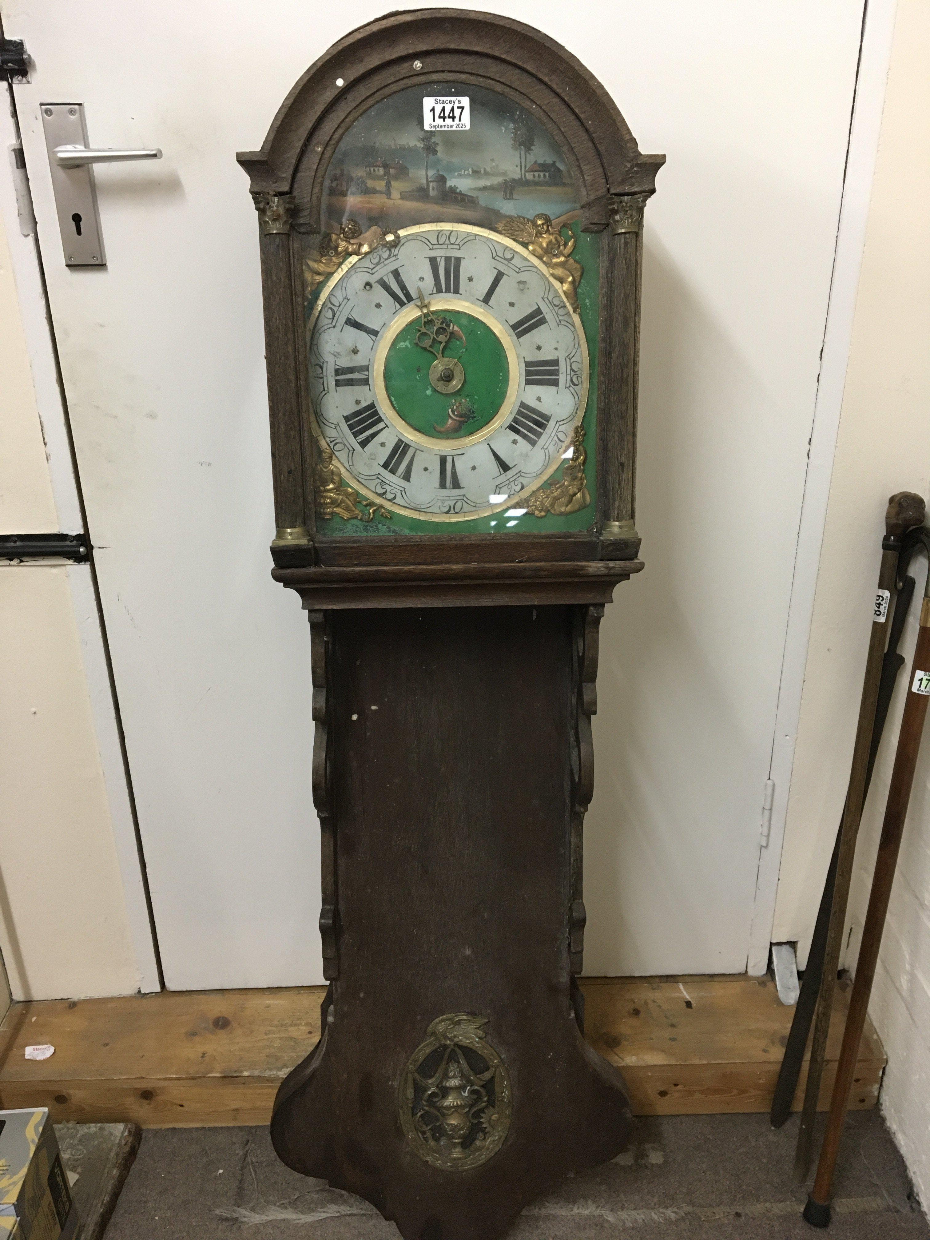 A 19th century Continental wall clock with a painted dial and brass weight restoration project