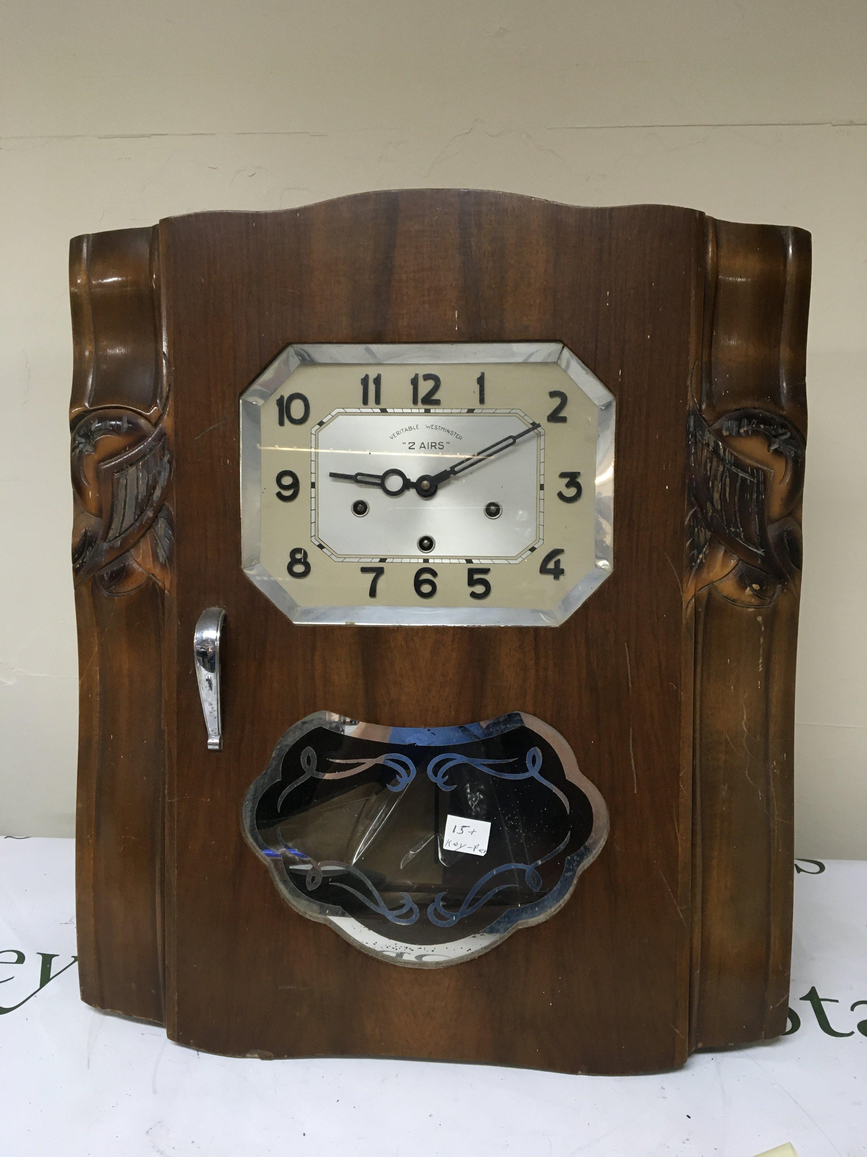 A Continental walnut cased Art Deco influenced wall clock with chrome mounts visible pendulum. The dial Veritable Westminster 2 Airs.