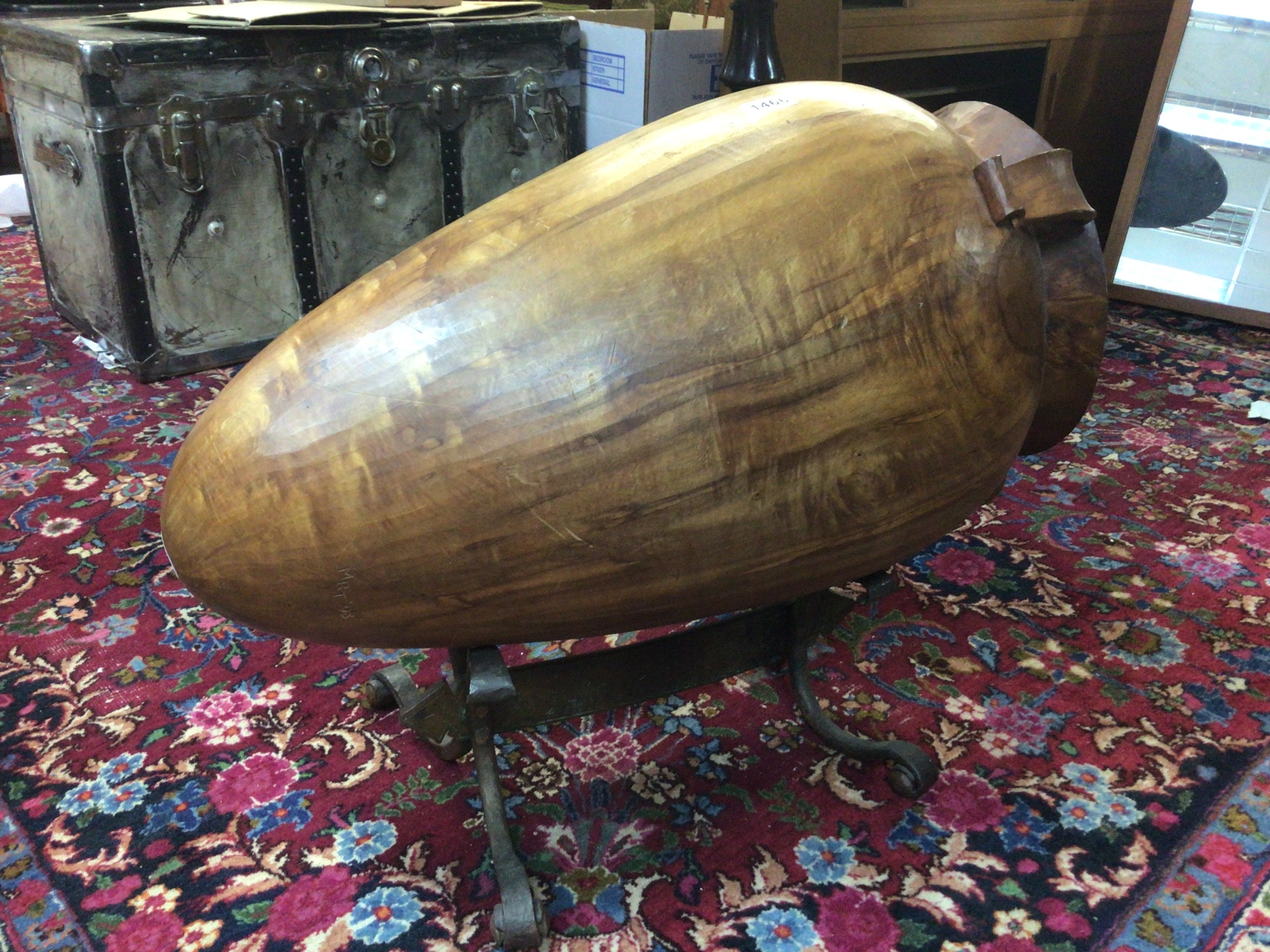 An unusual large carved wood Vessel on a crafted bispoke wrought metal copper stand. Length 80cm