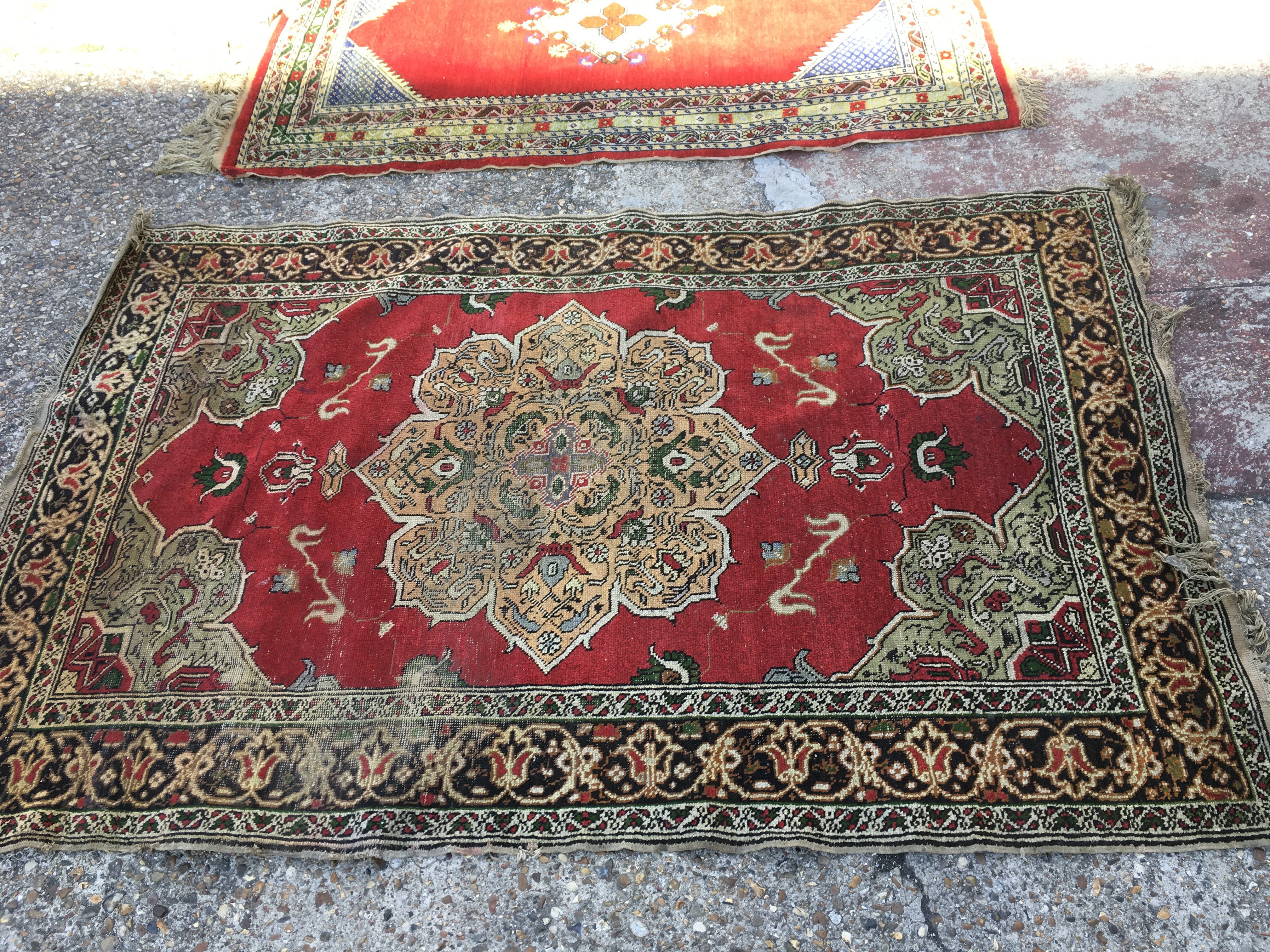 Two red hand woven Rugs. Dimensions 202x130cm and 110x180cm