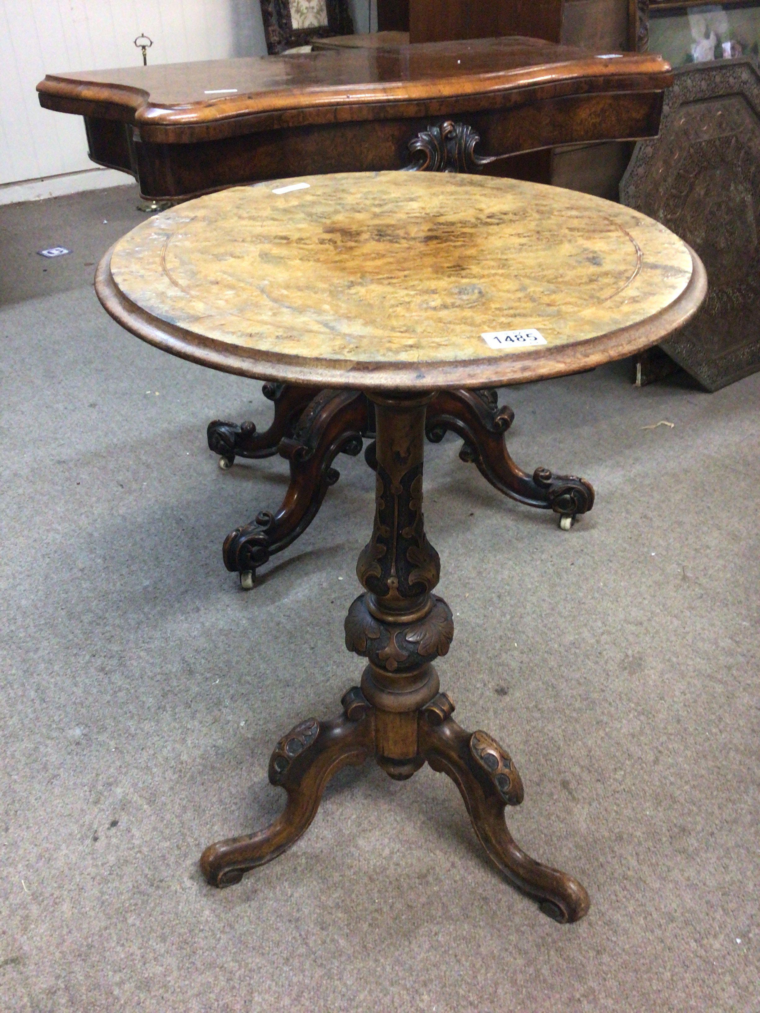 A Victorian walnut occasional table the circular top on a carved coloum. top loose.