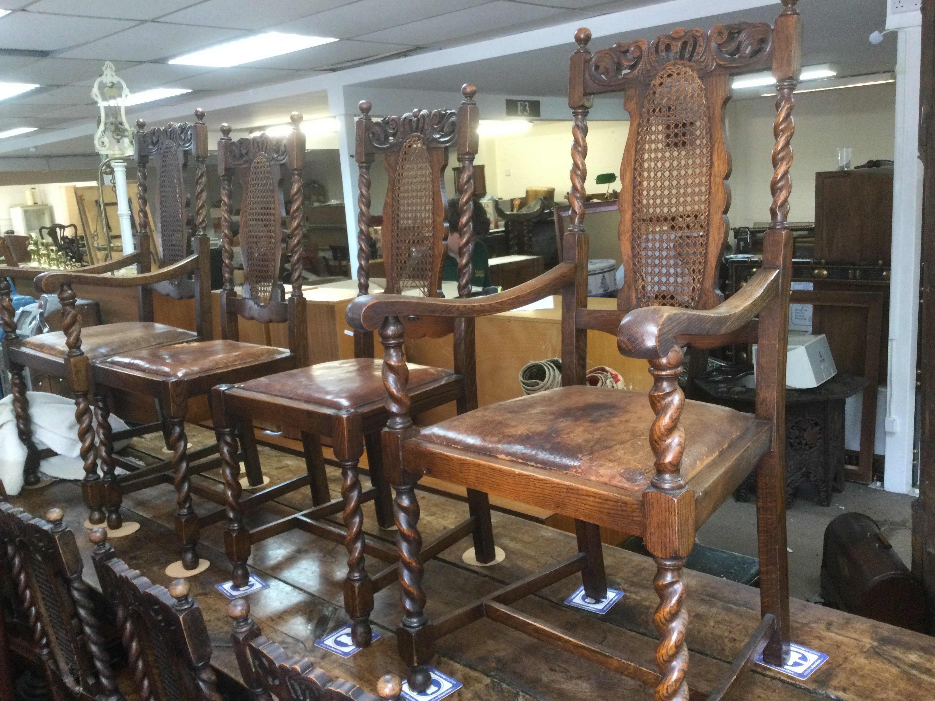 Six oak dining chairs and two carvers with carved top rails and barley twist supports. Shipping category D.