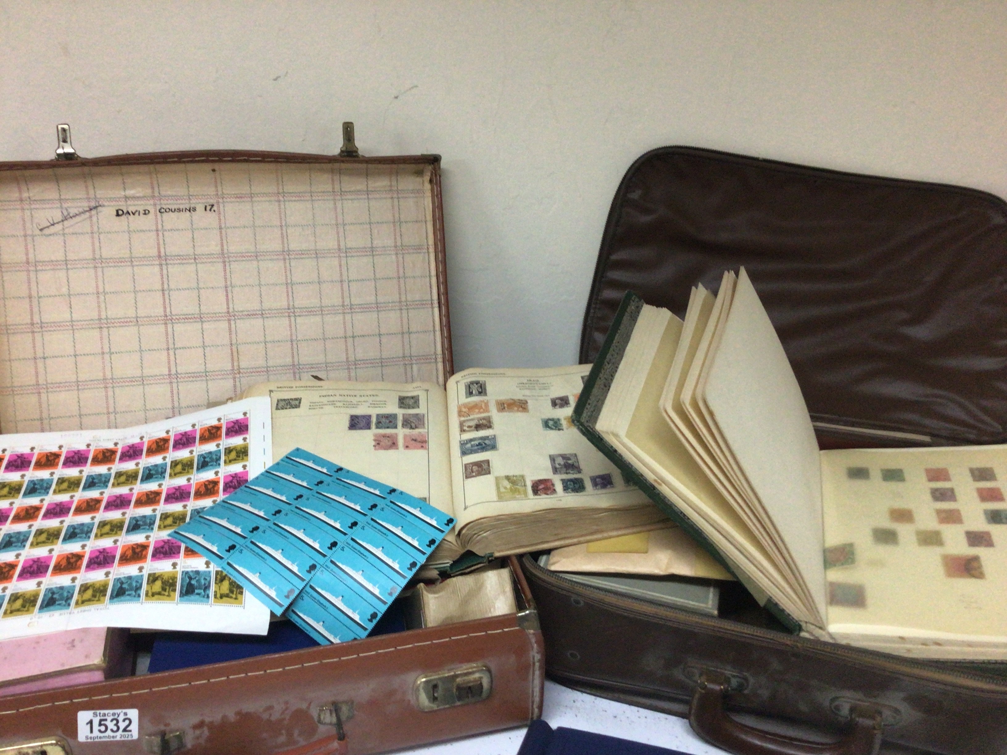 Two Cases containing World stamps in albums and unused British pre-decimal stamp sheets pictorial.An album virtually complete The Coronation of George VI British Commonwealth and Empire. World stamps in albums containing both used and unused stamps. Many loose an intresting collection.