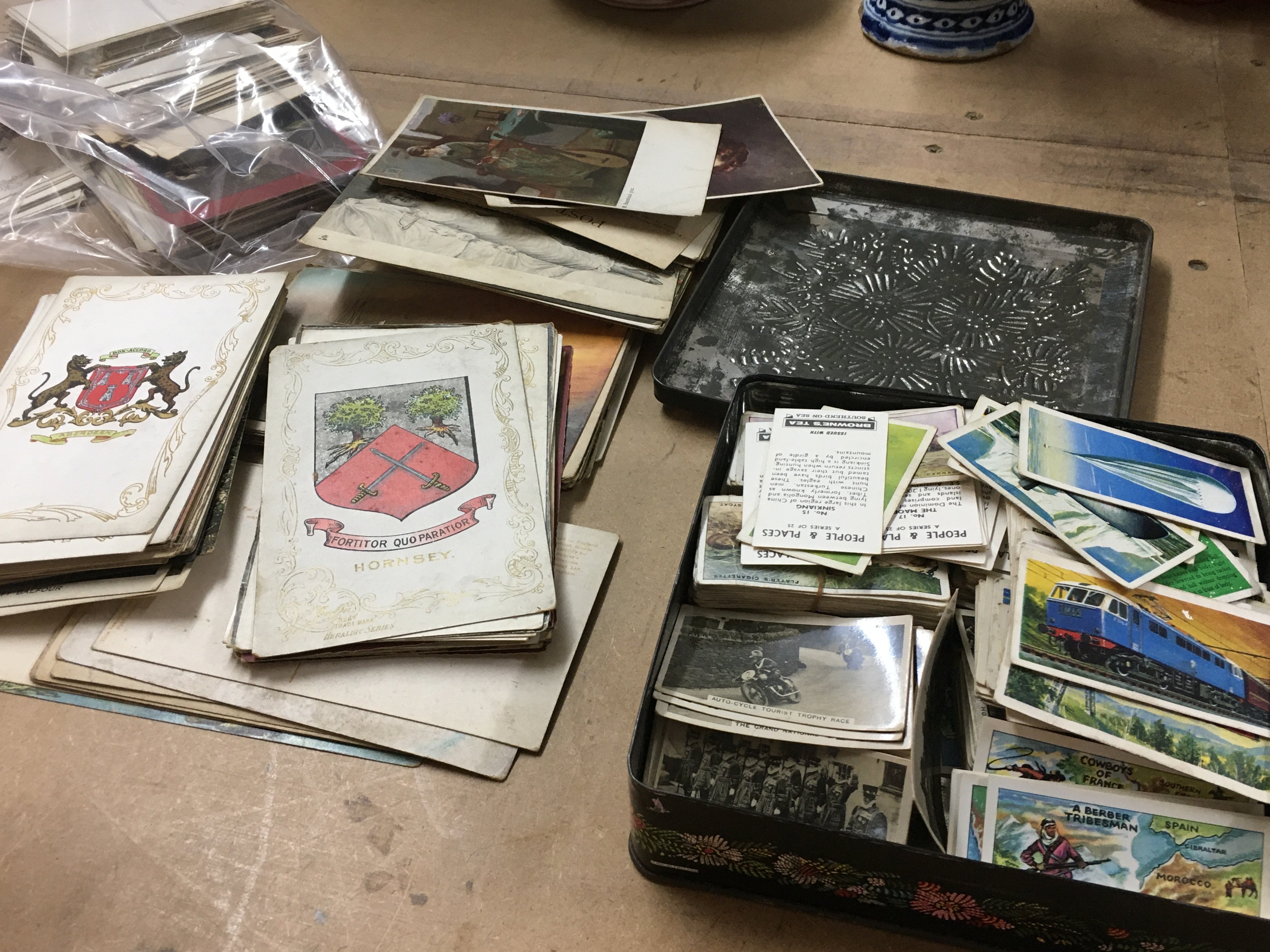 A collection of post cards and a collection of cigarettes .