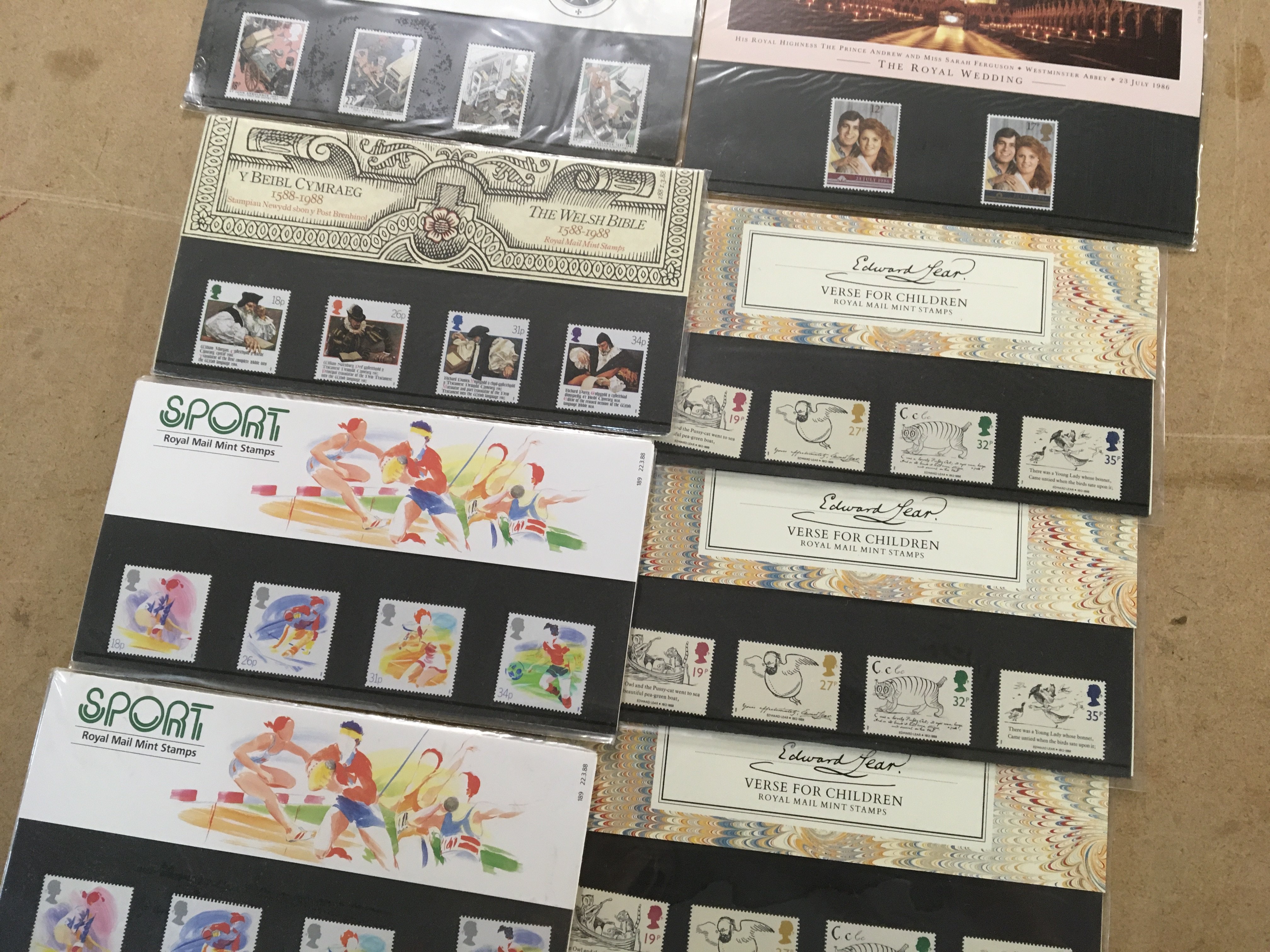 A box containing a large quantity of Royal Mail presentation packs.