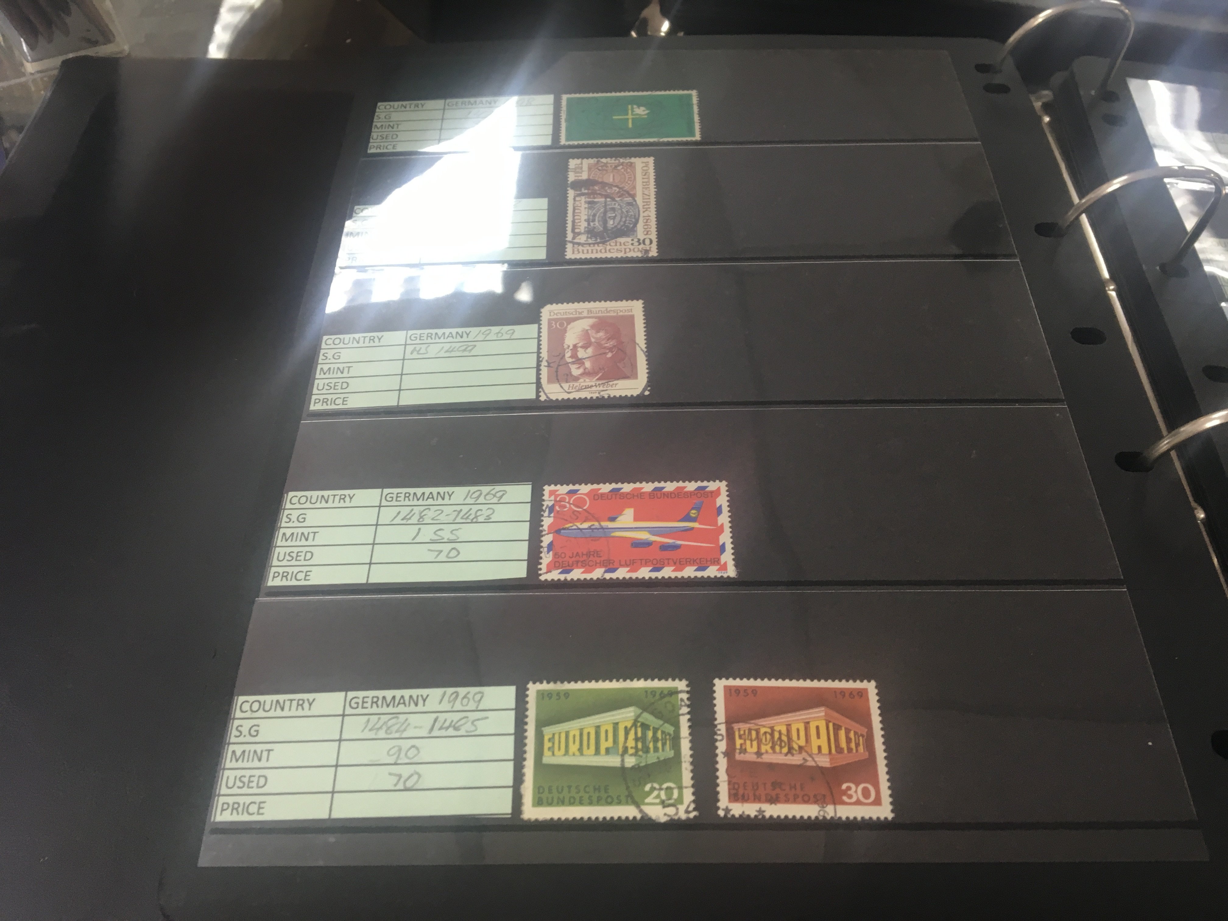 Three albums containing German stamps and channel Island stock books .