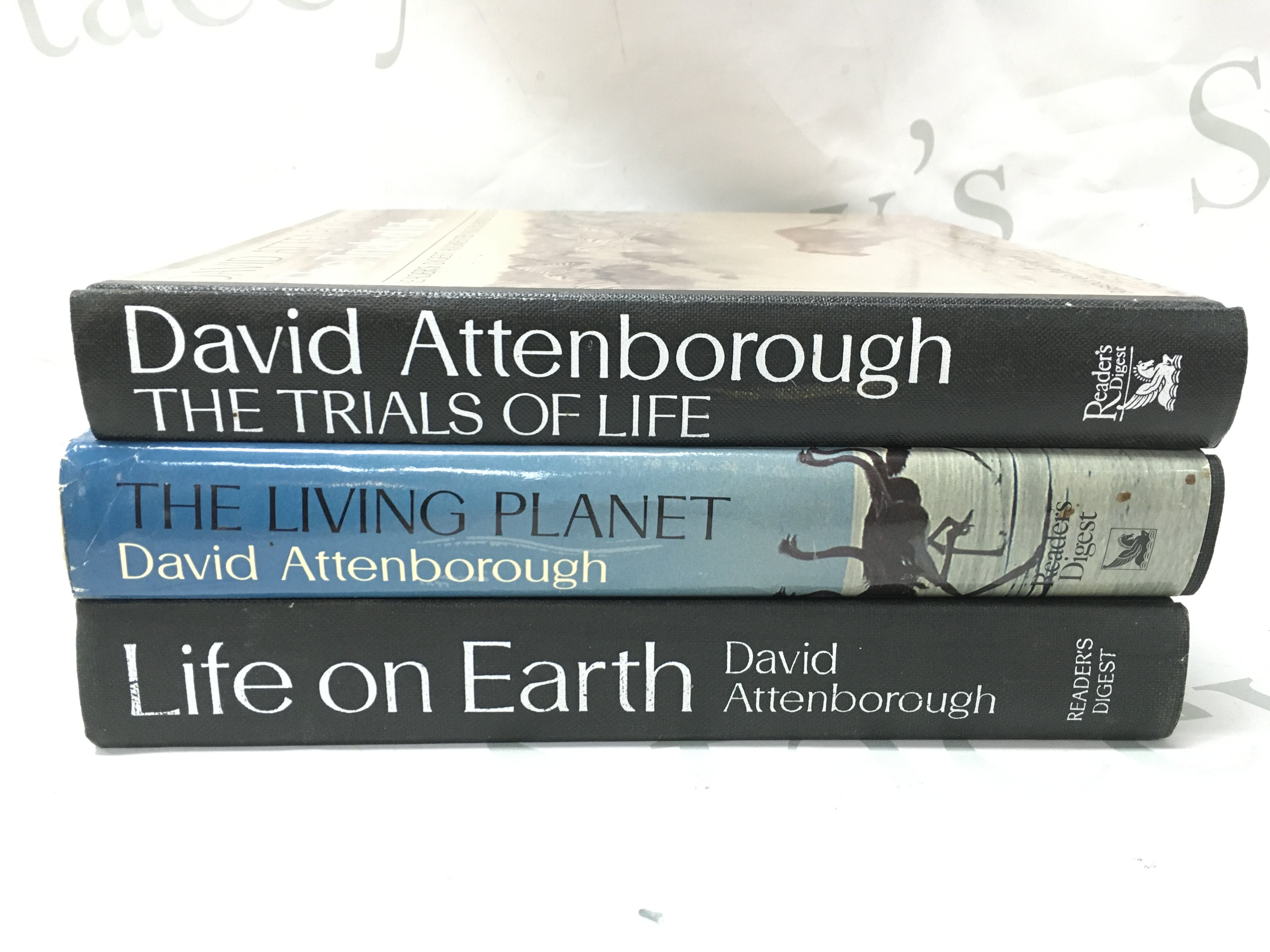 Three David Attenborough books- The Trials of life (signed) , The Living planet (signed) and Life on earth. Postage category C