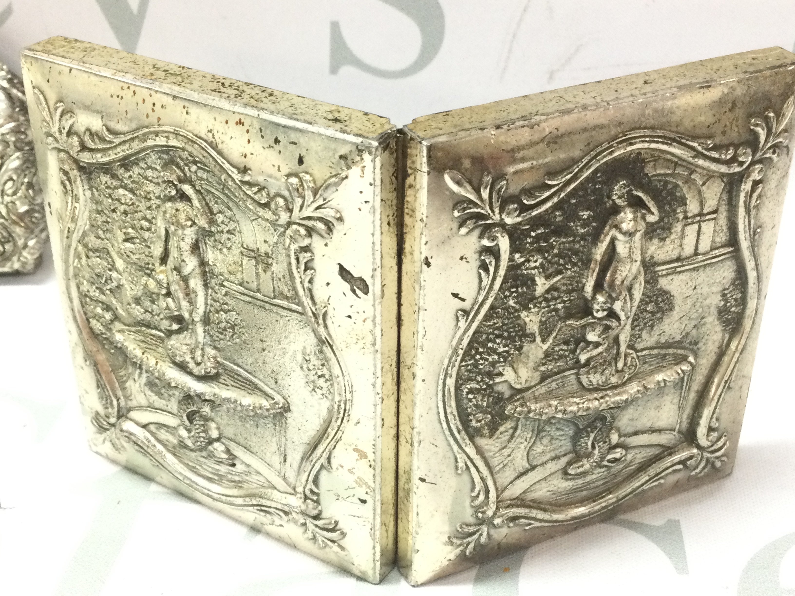 A small silver plate round hip flask decorated with two racehorses and a small heavy double photo frame embossed and a silver plated hanging item. Postage category B- NO RESERVE